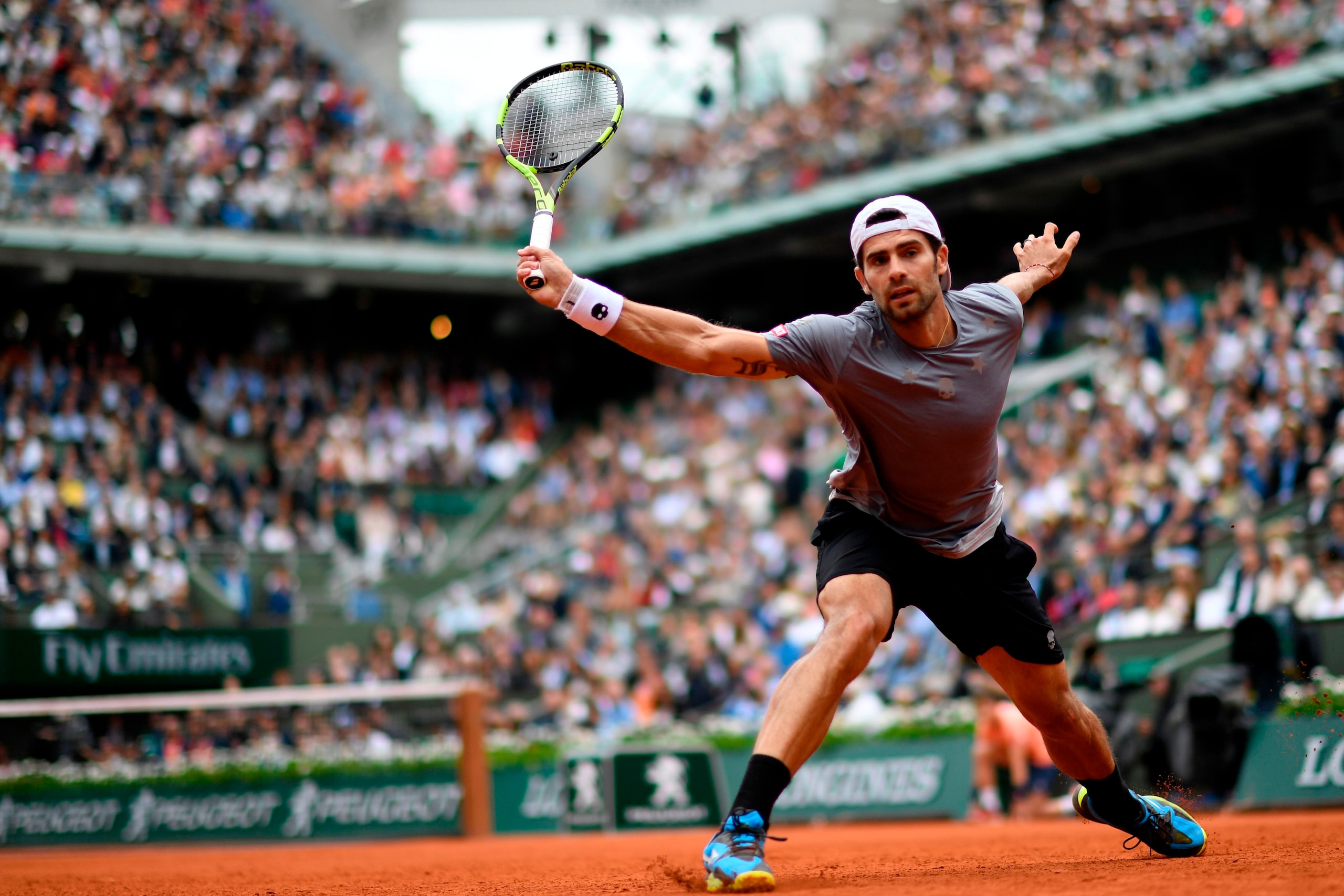Italy's Simone Bolelli plays a backhand return to Spain's Rafael Nadal during their men's singles first round match on day three of The Roland Garros 2018 French Open tennis tournament in Paris on May 29, 2018. (Photo by CHRISTOPHE SIMON / AFP) (Ph Italy's Simone Bolelli plays a backhand return to Spain's Rafael Nadal during their men's singles first round match on day three of The Roland Garros 2018 French Open tennis tournament in Paris on May 29, 2018. (Photo by CHRISTOPHE SIMON / AFP) (Ph