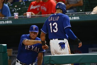 ARLINGTON, TX - MAY 24: Jeff Banister #28 of the Texas Rangers congratulates Joey Gallo #13 for scores in the in the eighth inning against the Kansas City Royals at Globe Life Park in Arlington on May 24, 2018 in Arlington, Texas. (Photo by Rick Yeatts/Ge