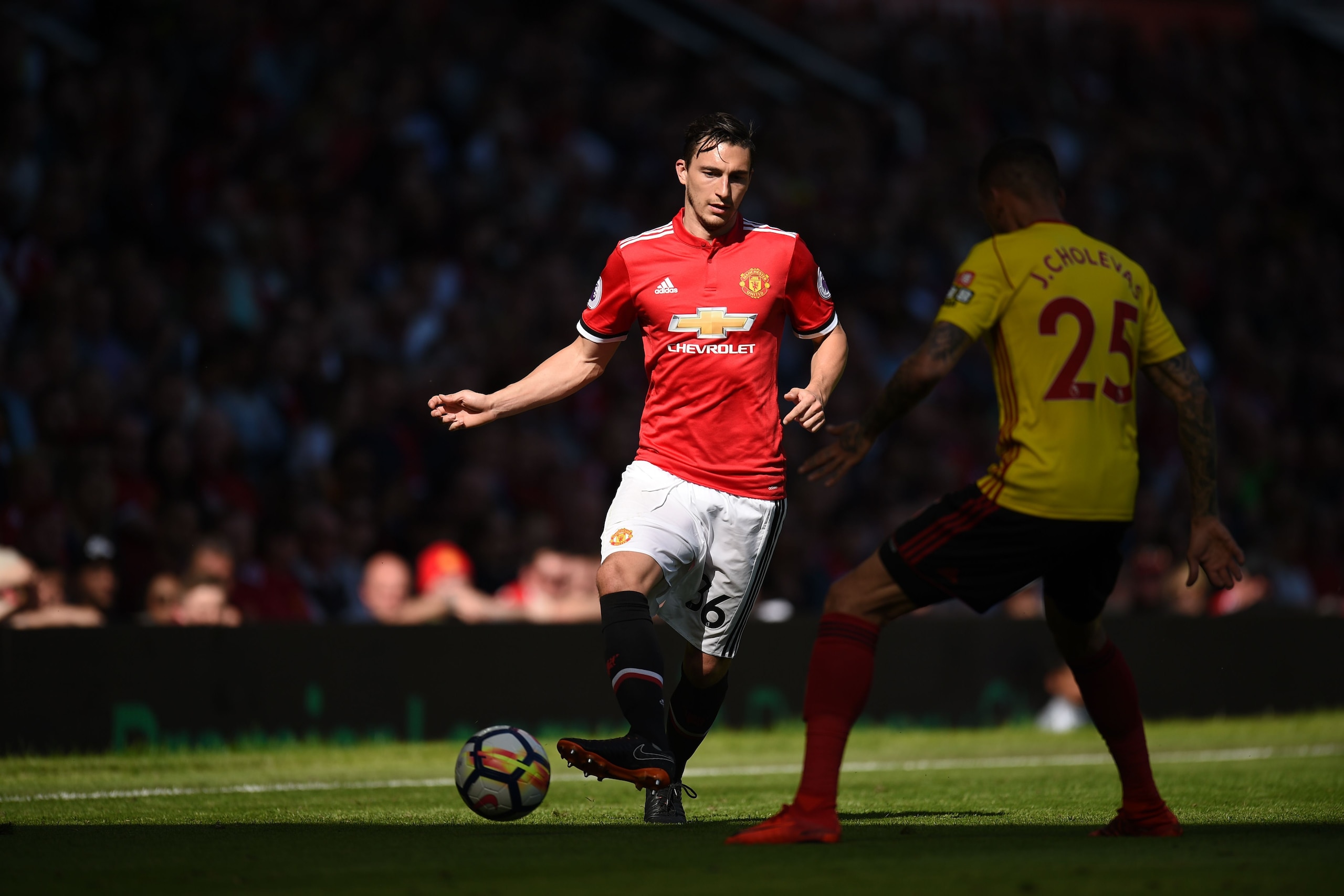Manchester United's Italian defender Matteo Darmian (L) players the ball around Watford's German-born Greek midfielder José Holebas (R) during the English Premier League football match between Manchester United and Watford at Old Trafford in Manchester, n