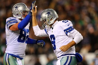 PHILADELPHIA, PA - DECEMBER 14:  Tony Romo #9 of the Dallas Cowboys high fives Jason Witten #82 after a touchdown in the first quarter against the Philadelphia Eagles at Lincoln Financial Field on December 14, 2014 in Philadelphia, Pennsylvania.  (Photo b
