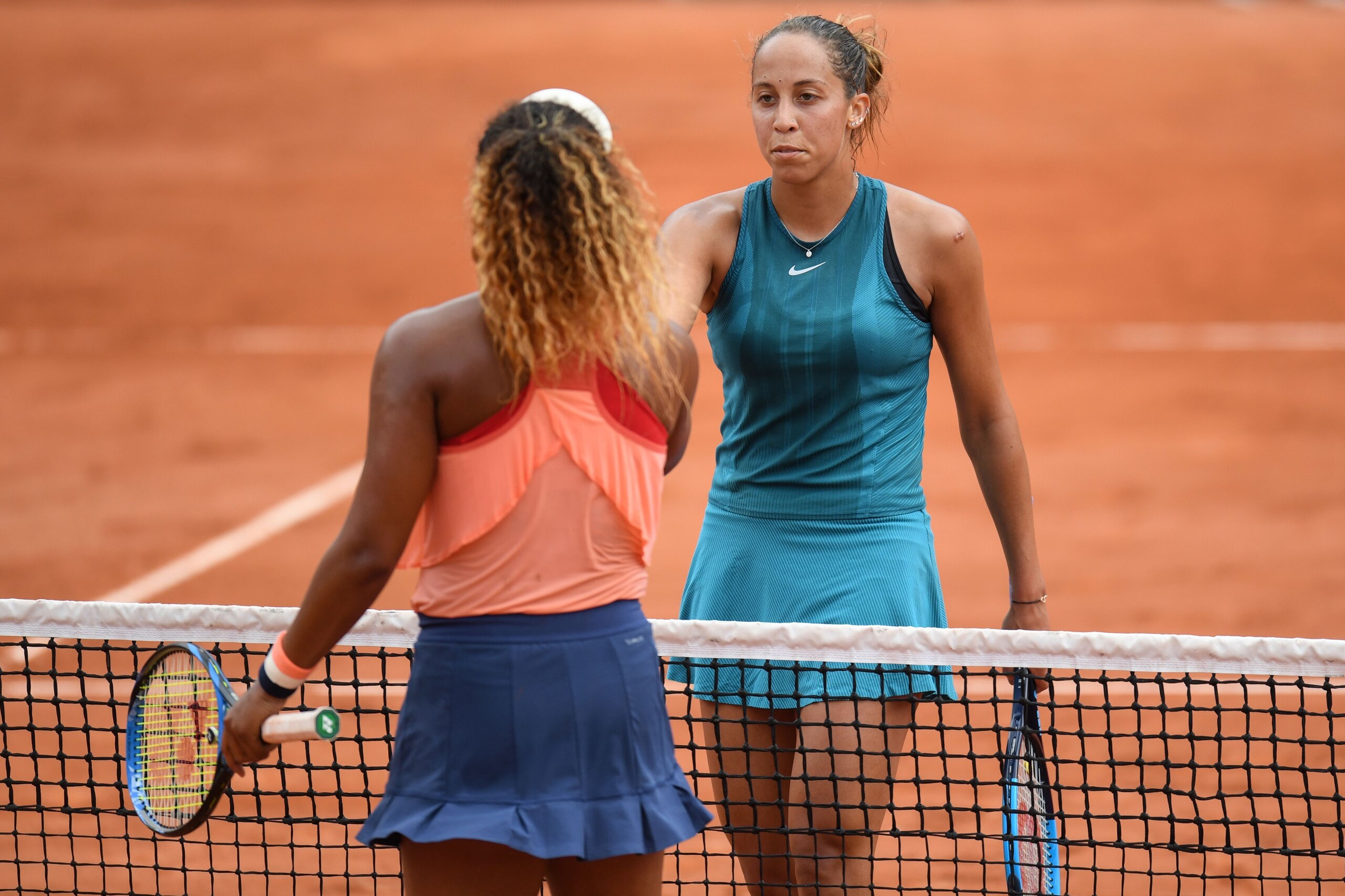 Madison Keys of the US (R) is congratulated by Japan's Naomi Osaka after winning, at the end of their women's singles third round match on day six of The Roland Garros 2018 French Open tennis tournament in Paris on June 1, 2018. (Photo by CHRISTOPHE ARCHA