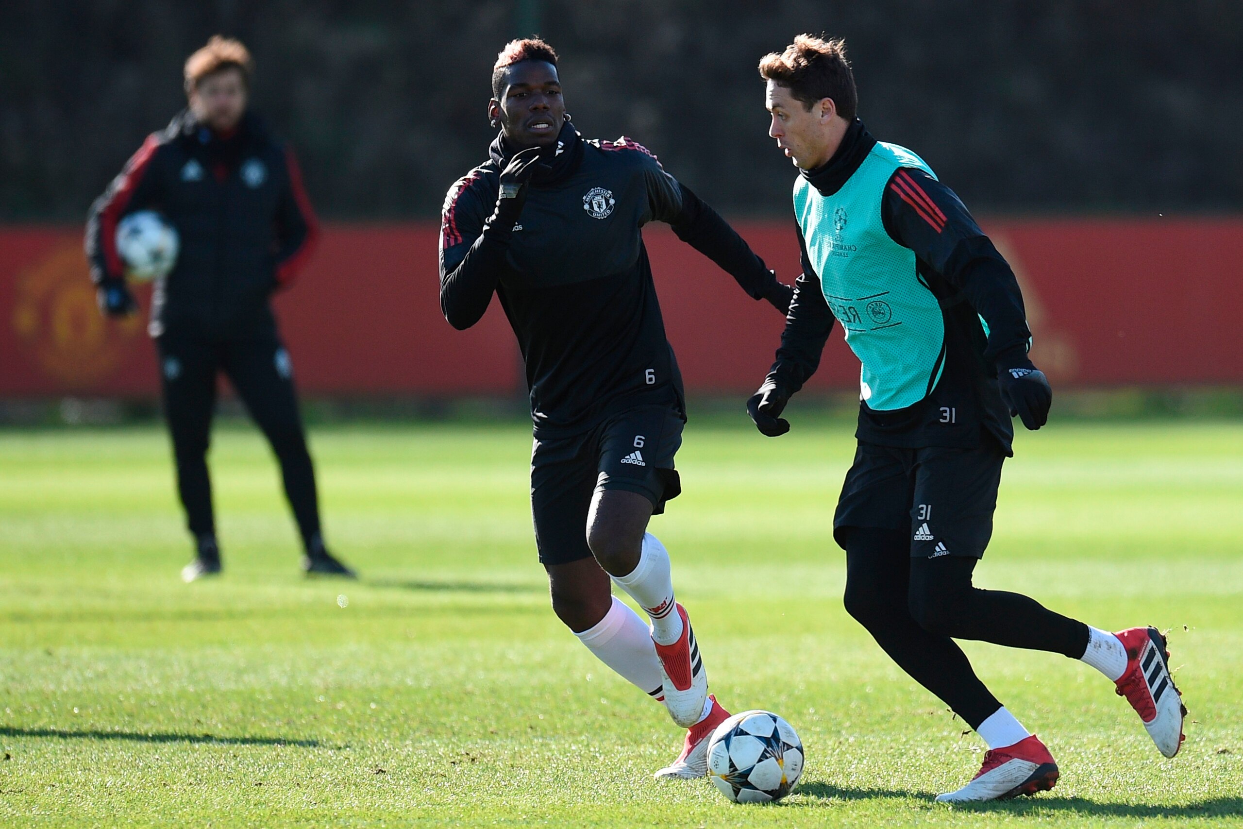 Manchester United's Serbian midfielder Nemanja Matic (R) and Manchester United's French midfielder Paul Pogba (L) take part in a team training session at the club's training complex near Carrington, west of Manchester in north west England on February 20,