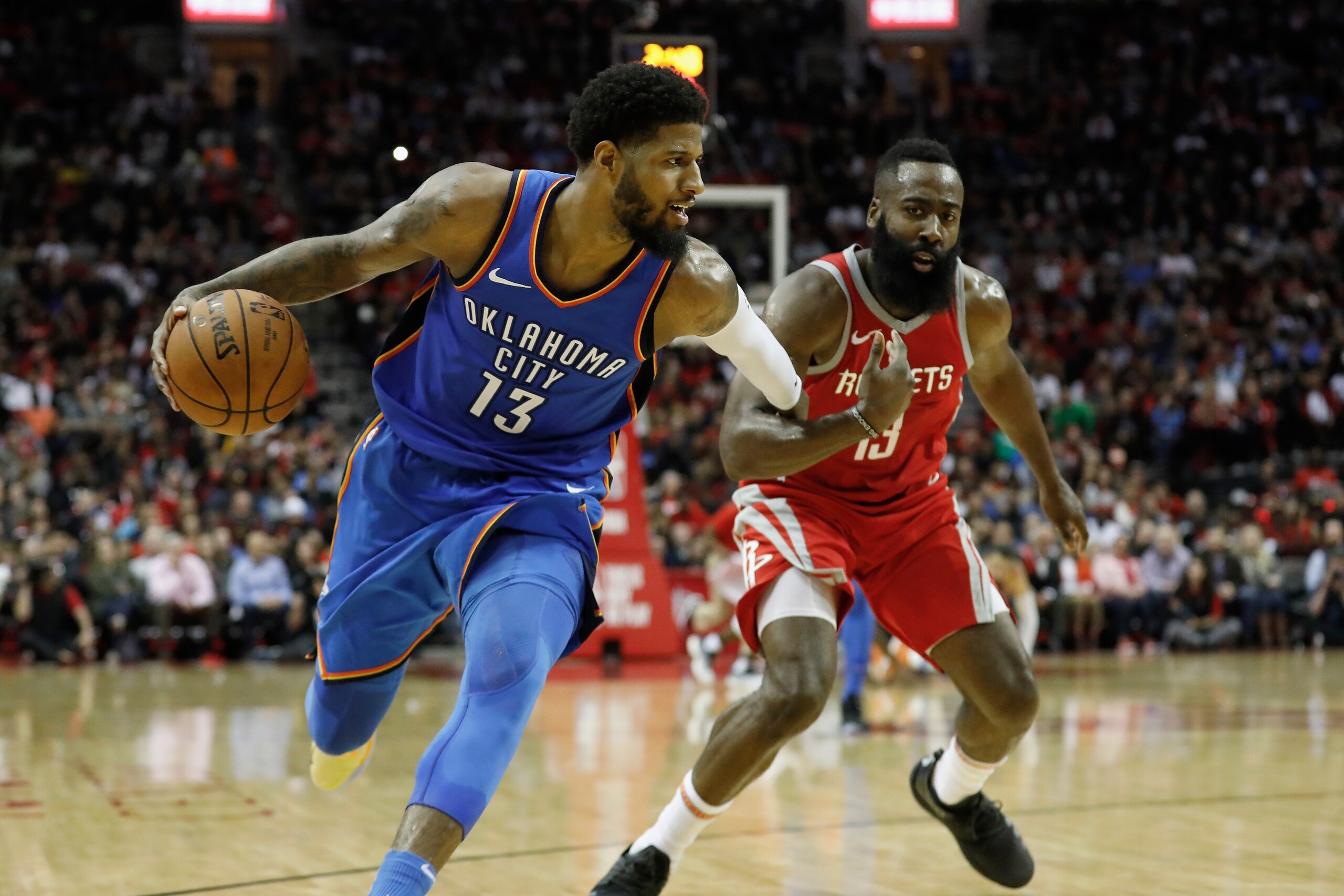HOUSTON, TX - APRIL 07:  Paul George #13 of the Oklahoma City Thunder drives to the basket defended by James Harden #13 of the Houston Rockets in the second half at Toyota Center on April 7, 2018 in Houston, Texas.  NOTE TO USER: User expressly acknowledg