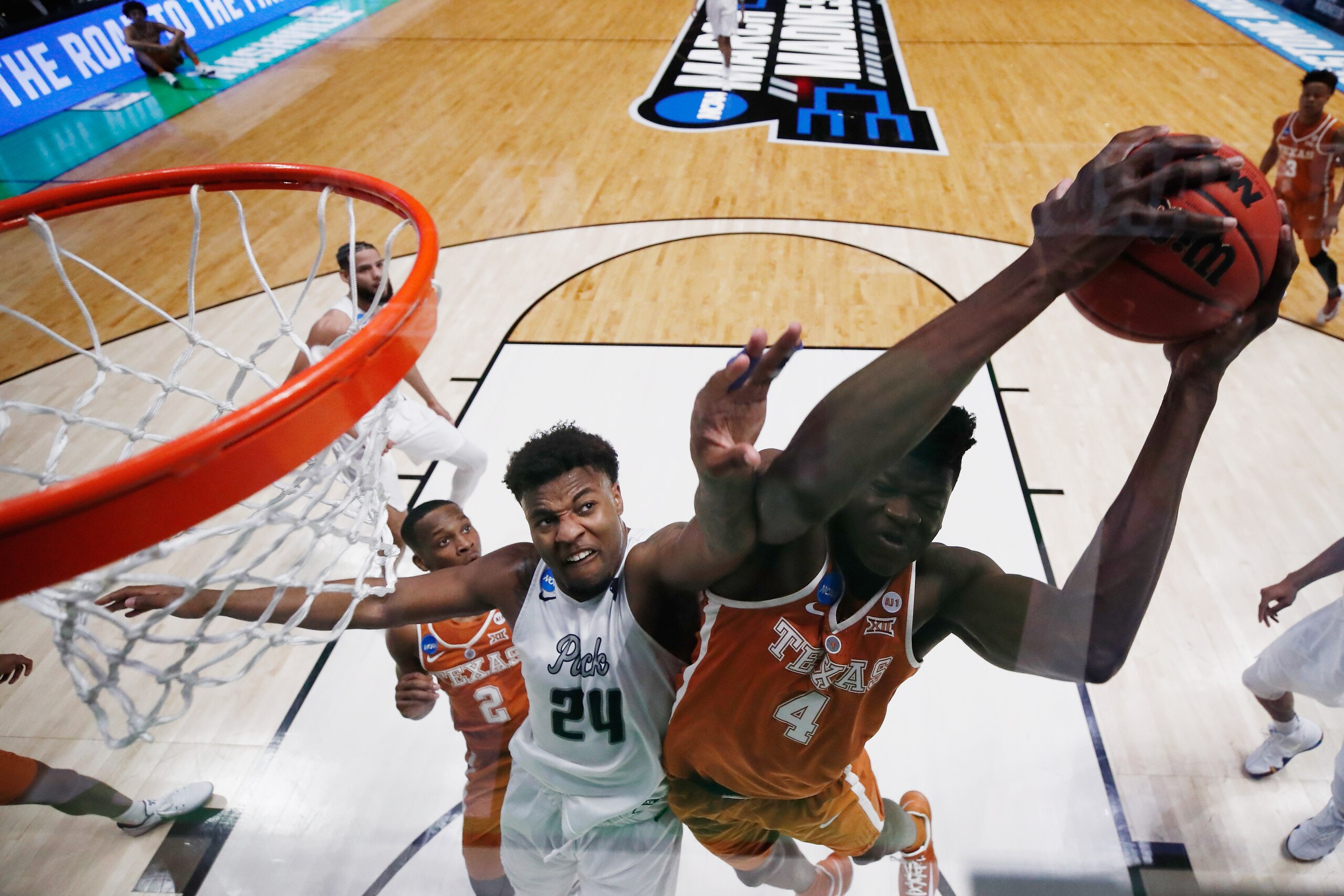 NASHVILLE, TN - MARCH 16:  Mohamed Bamba #4 of the Texas Longhorns grabs a rebound from Jordan Caroline #24 of the Nevada Wolf Pack during the game in the first round of the 2018 NCAA Men's Basketball Tournament at Bridgestone Arena on March 16, 2018 in N