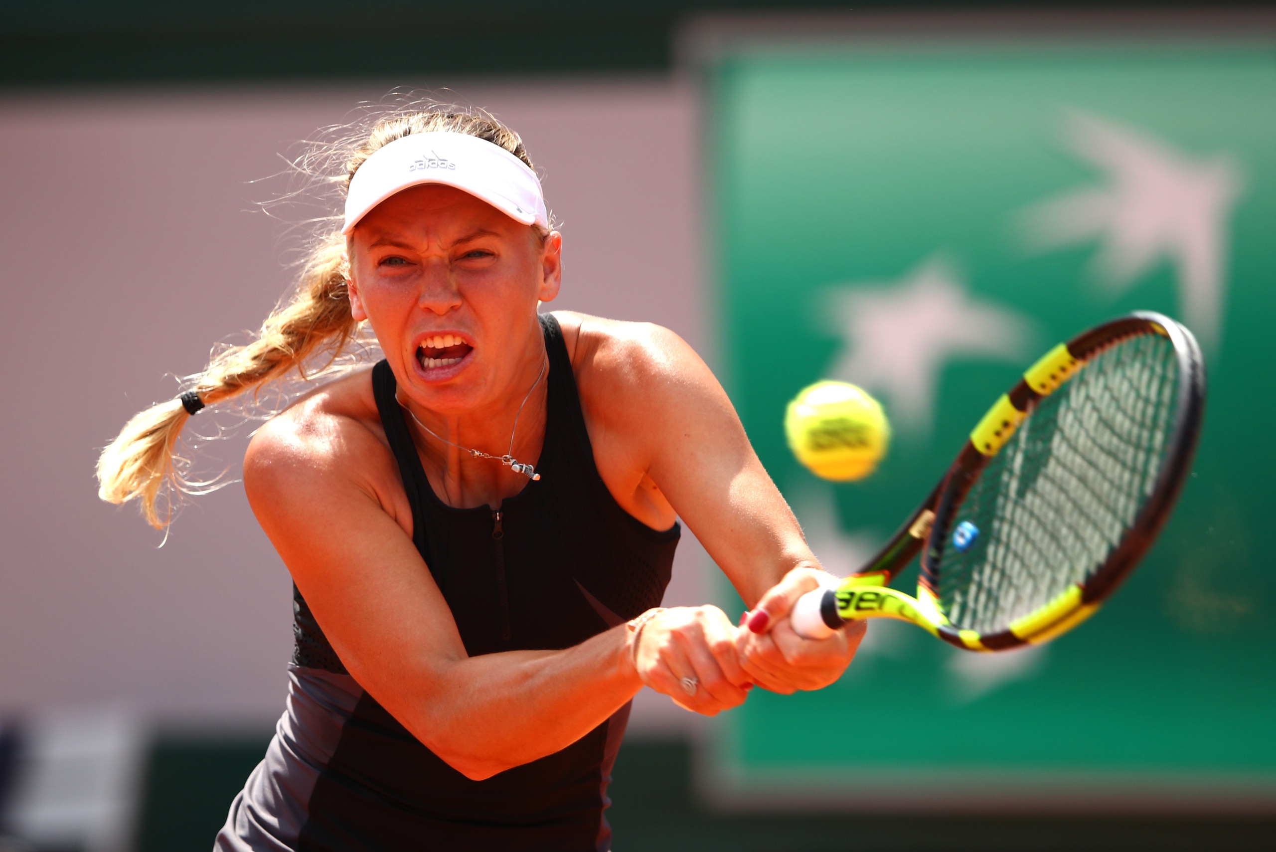 PARIS, FRANCE - JUNE 04:  Caroline Wozniacki of Denmark plays a backhand during the ladies singles fourth round match against Daria Kasatkina of Russia during day nine of the 2018 French Open at Roland Garros on June 4, 2018 in Paris, France.  (Photo by C