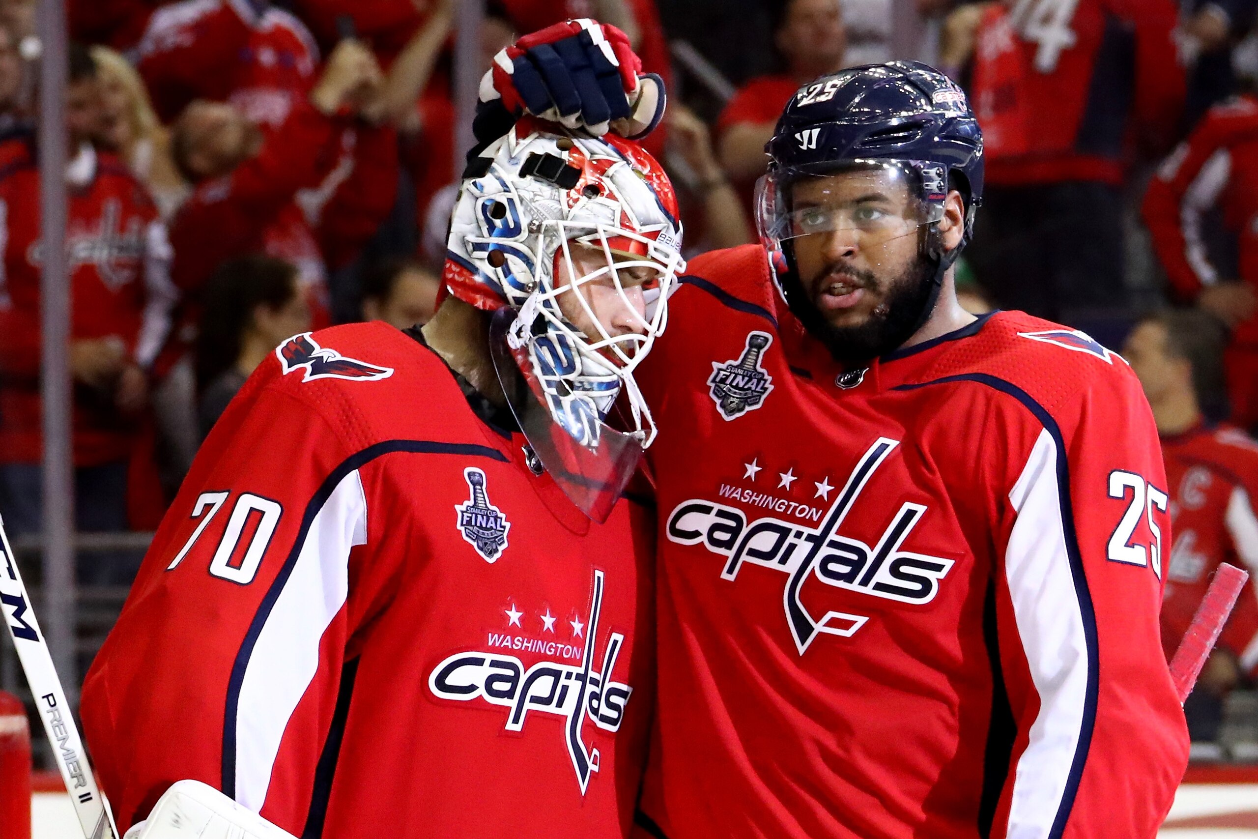 WASHINGTON, DC - JUNE 04:  Braden Holtby #70 and Devante Smith-Pelly #25 of the Washington Capitals celebrate their team's 6-2 win over the Vegas Golden Knights in Game Four of the 2018 NHL Stanley Cup Final at Capital One Arena on June 4, 2018 in Washing