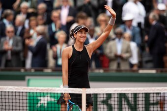 PARIS, FRANCE - JUNE 06:  Garbine Muguruza of Spain reacts after winning her women's singles quaterfinal match against Maria Sharapova of Russia on day 11 of the 2018 French Open at Roland Garros on June 6, 2018 in Paris, France.  (Photo by XIN LI/Getty I