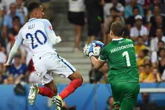 Iceland's goalkeeper Hannes Thor Halldorsson (R) saves the ball in front of England's midfielder Dele Alli during Euro 2016 round of 16 football match between England and Iceland at the Allianz Riviera stadium in Nice on June 27, 2016.   / AFP / ANNE-CHRI