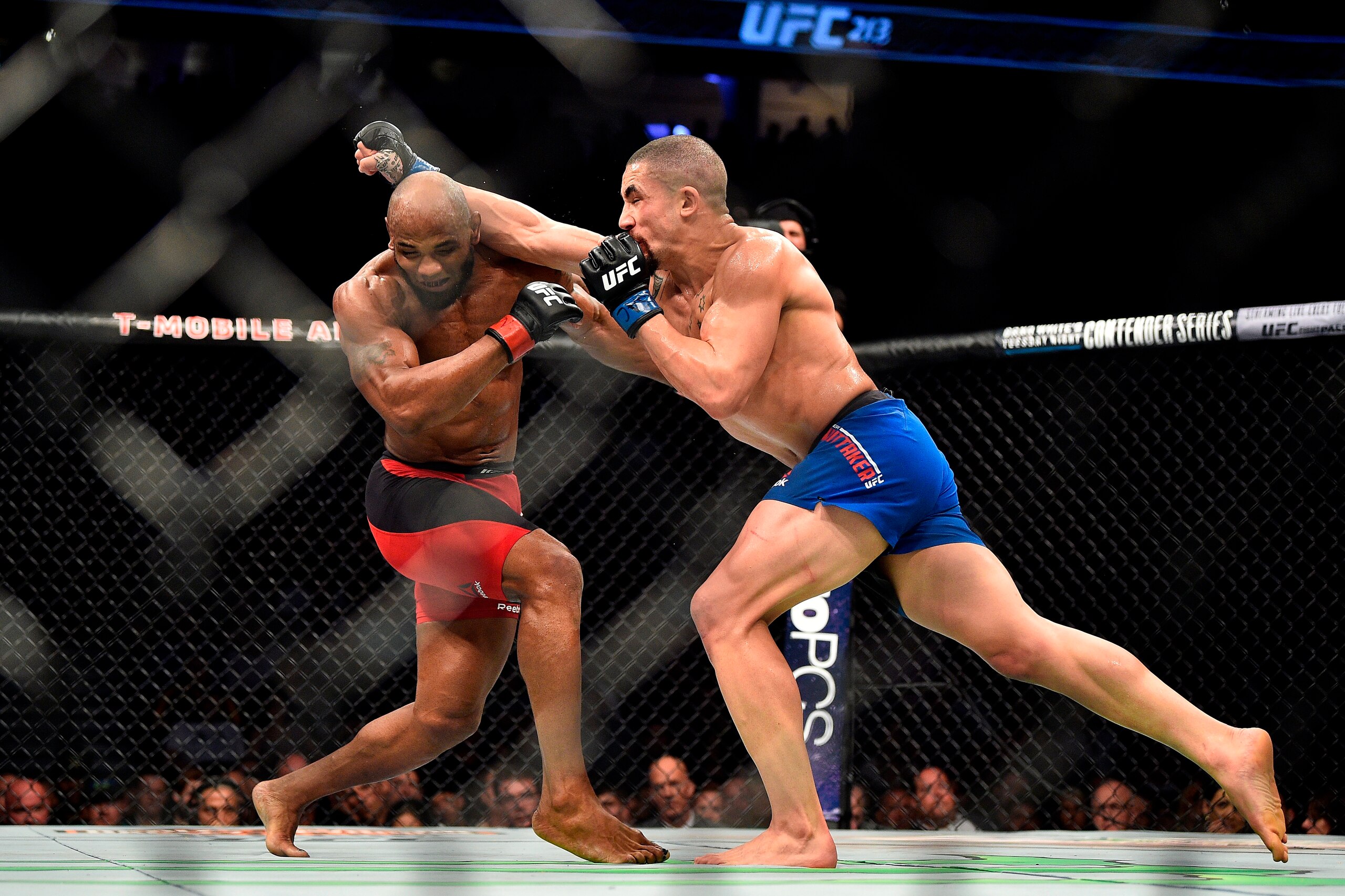 LAS VEGAS, NV - JULY 08:  (R-L) Robert Whittaker of New Zealand punches Yoel Romero of Cuba in their interim UFC middleweight championship bout during the UFC 213 event at the T-Mobile Arena on July 8, 2017 in Las Vegas, Nevada. (Photo by Jeff Bottari/Zuf