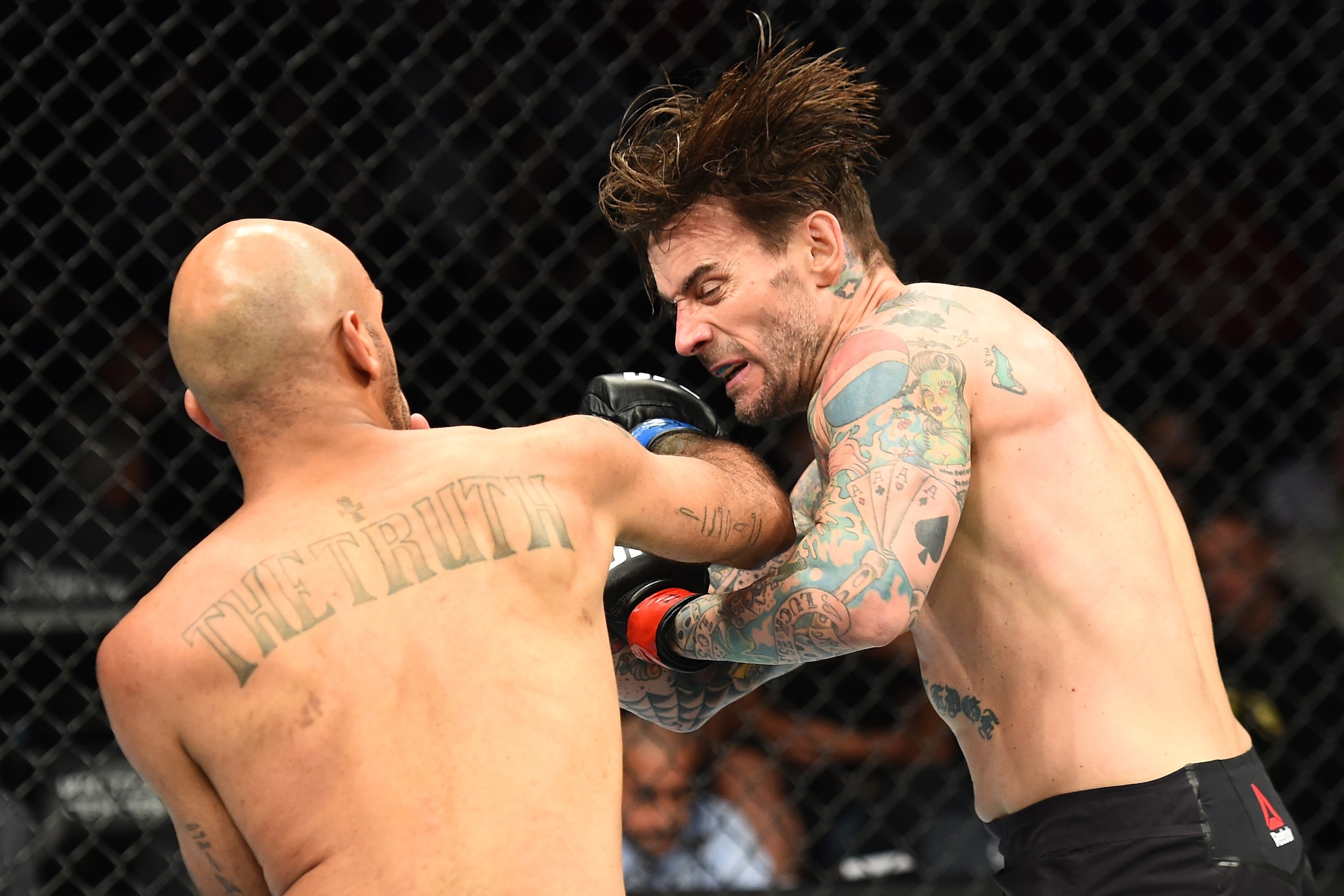 CHICAGO, ILLINOIS - JUNE 09:  (L-R) Mike Jackson punches CM Punk in their welterweight fight during the UFC 225 event at the United Center on June 9, 2018 in Chicago, Illinois. (Photo by Josh Hedges/Zuffa LLC/Zuffa LLC via Getty Images)