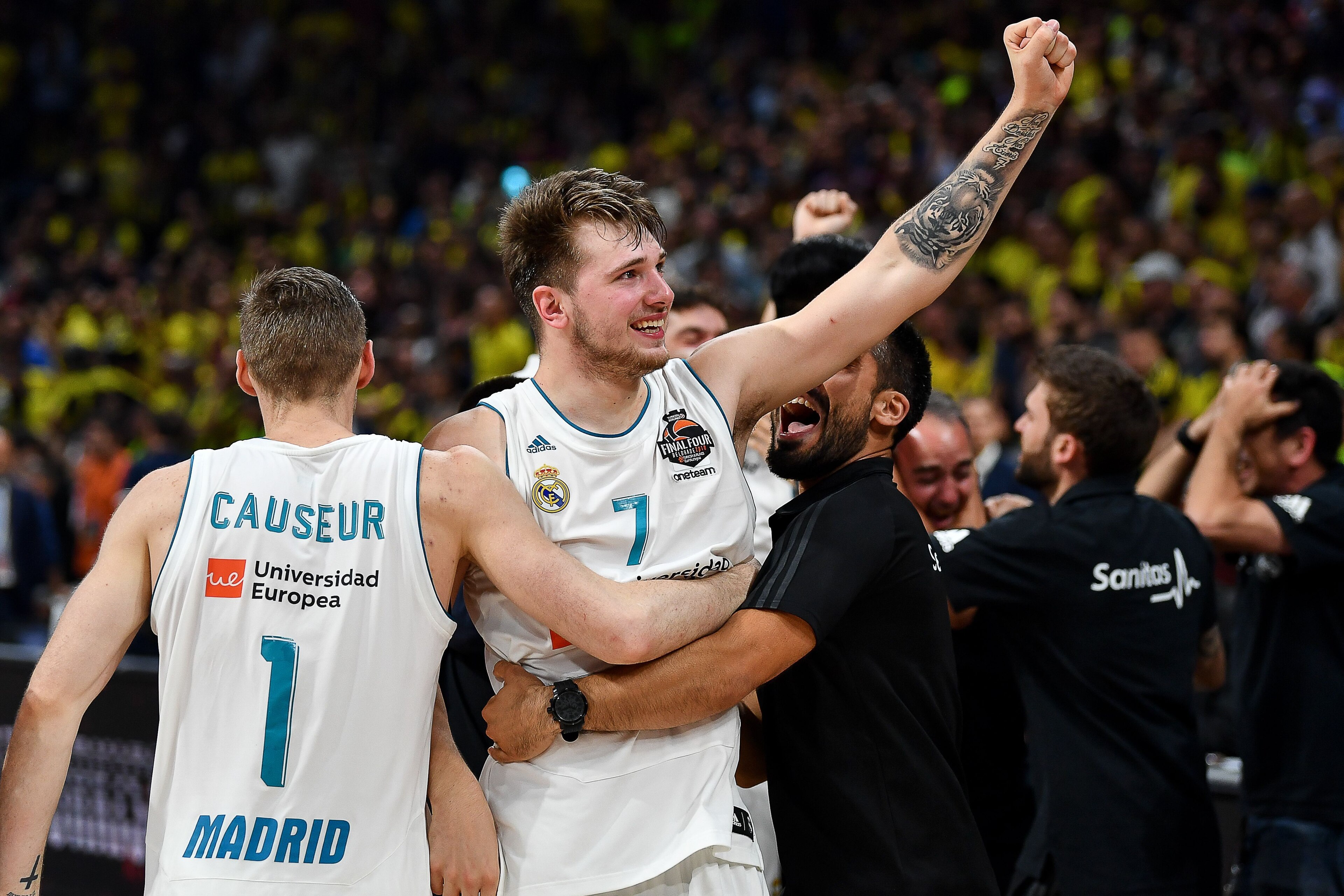 Real Madrid's Slovenian Luka Doncic (R) celebrates with team mate Real Madrid's French forward Fabien Causeur their team's 85-80 win in the Euroleague Final Four finals basketball match between Real Madrid and Fenerbahce Dogus Istanbul at The Stark Arena 