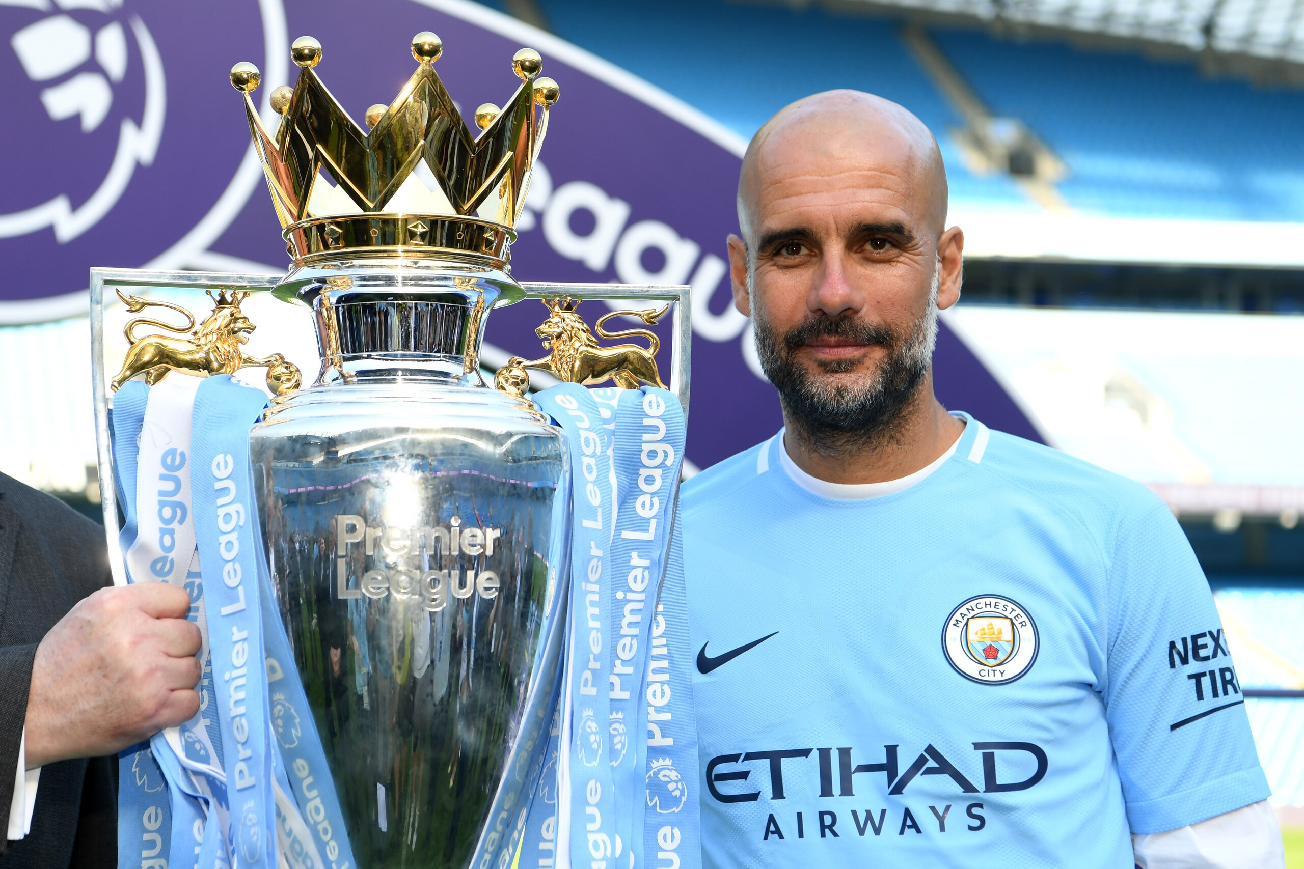 MANCHESTER, ENGLAND - MAY 06:  Josep Guardiola, Manager of Manchester City poses with The Premier League Trophy after the Premier League match between Manchester City and Huddersfield Town at Etihad Stadium on May 6, 2018 in Manchester, England.  (Photo b