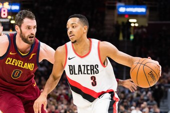 CLEVELAND, OH - JANUARY 2: Kevin Love #0 of the Cleveland Cavaliers tries to stop CJ McCollum #3 of the Portland Trail Blazers during the second half at Quicken Loans Arena on January 2, 2018 in Cleveland, Ohio. The Cavaliers defeated the Trail Blazers 12