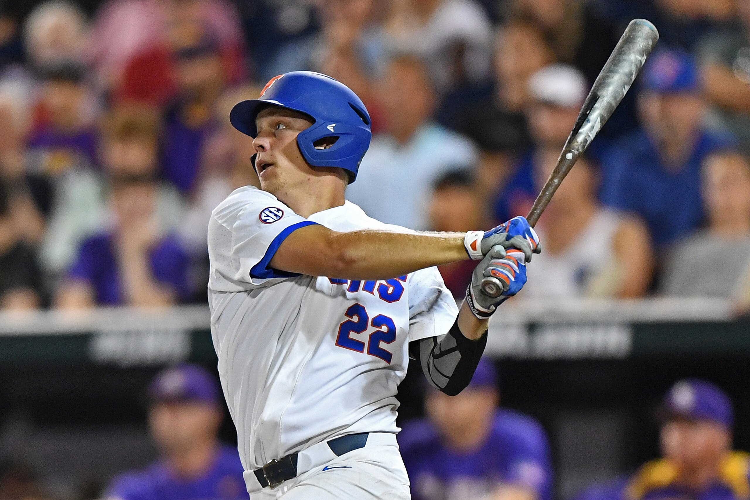 OMAHA, NE - JUNE 27: First basemen J.J Schwarz #22 of the Florida Gators drives in a run with a sacrifice fly against the LSU Tigers in the eighth inning during game two of the College World Series Championship Series on June 27, 2017 at TD Ameritrade Pa OMAHA, NE - JUNE 27: First basemen J.J Schwarz #22 of the Florida Gators drives in a run with a sacrifice fly against the LSU Tigers in the eighth inning during game two of the College World Series Championship Series on June 27, 2017 at TD Ameritrade Pa