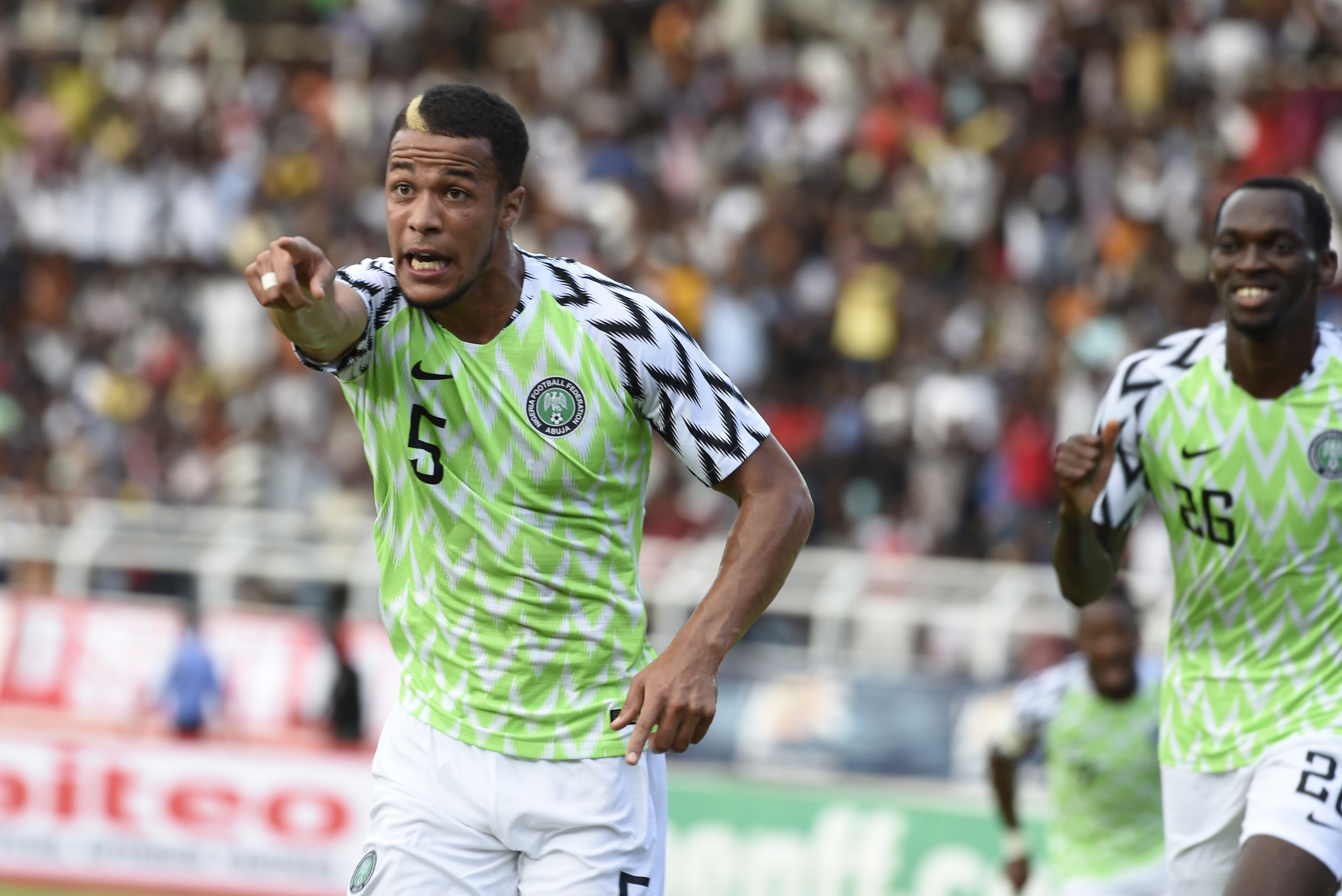Nigerian defender William Ekong (L) points to the crowd to celebrate his goal during an international friendly football match between Nigeria and DR Congo on May 28.