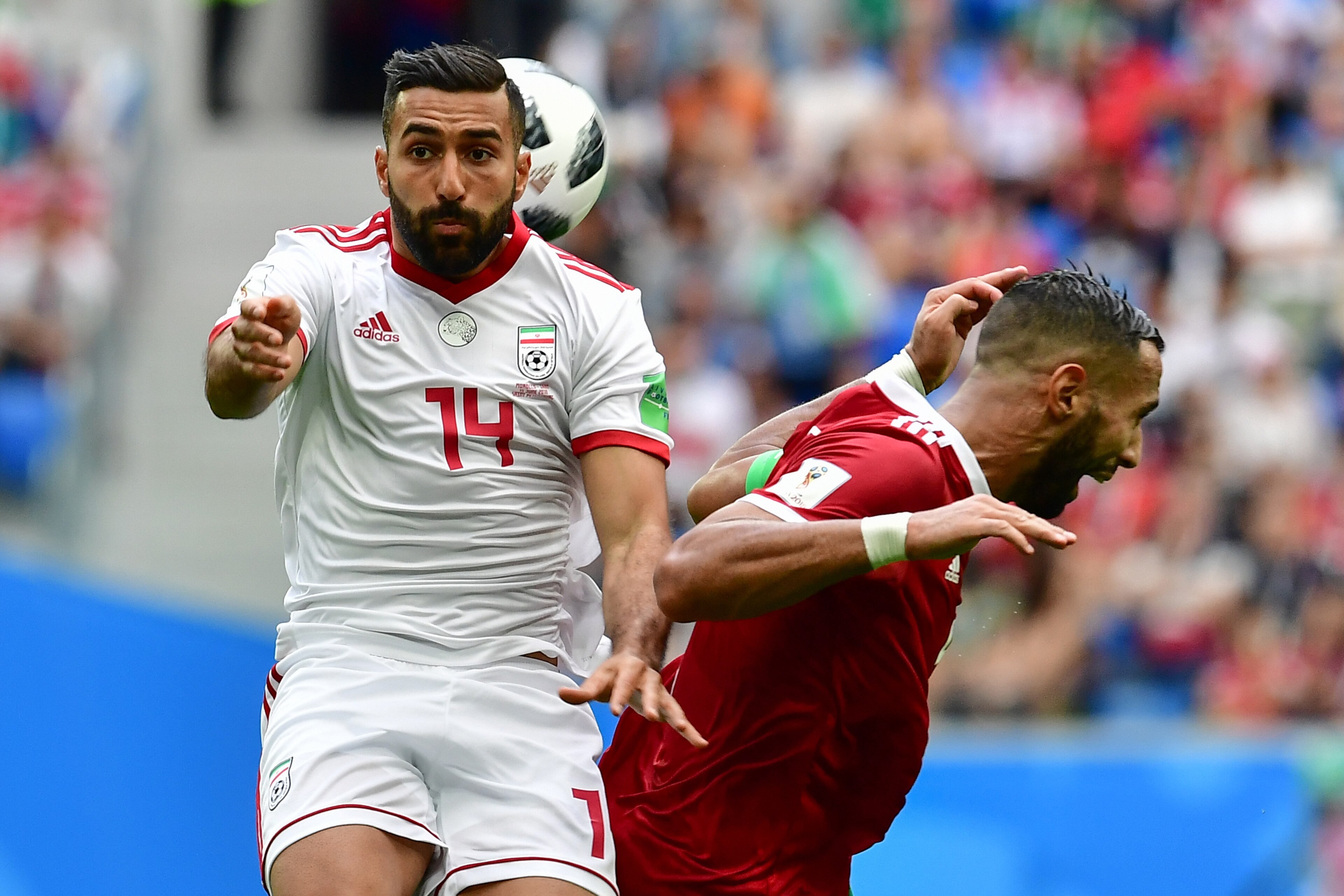 Iran's forward Saman Ghoddos (L) vies for the ball with Morocco's defender Mehdi Benatia during the Russia 2018 World Cup Group B football match between Morocco and Iran at the Saint Petersburg Stadium in Saint Petersburg on June 15, 2018. (Photo by Giuse