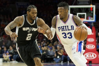 PHILADELPHIA, PA - FEBRUARY 8: Robert Covington #33 of the Philadelphia 76ers drives to the basket against Kawhi Leonard #2 of the San Antonio Spurs at the Wells Fargo Center on February 8, 2017 in Philadelphia, Pennsylvania. The Spurs defeated the 76ers 