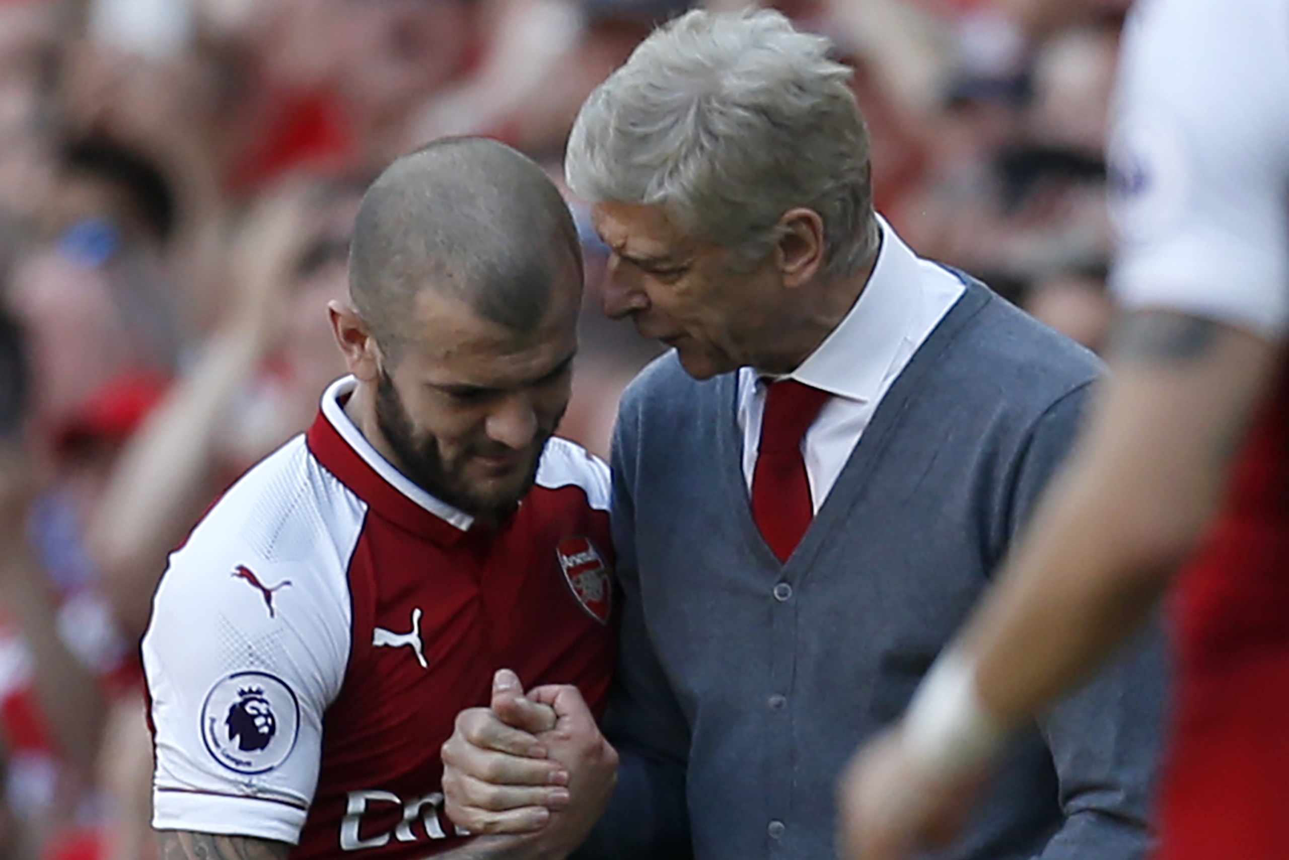 Arsenal's French manager Arsene Wenger (R) speaks with Arsenal's English midfielder Jack Wilshere (L) after he comes off during the English Premier League football match between Arsenal and Burnley at the Emirates Stadium in London on May 6, 2018. (Photo 