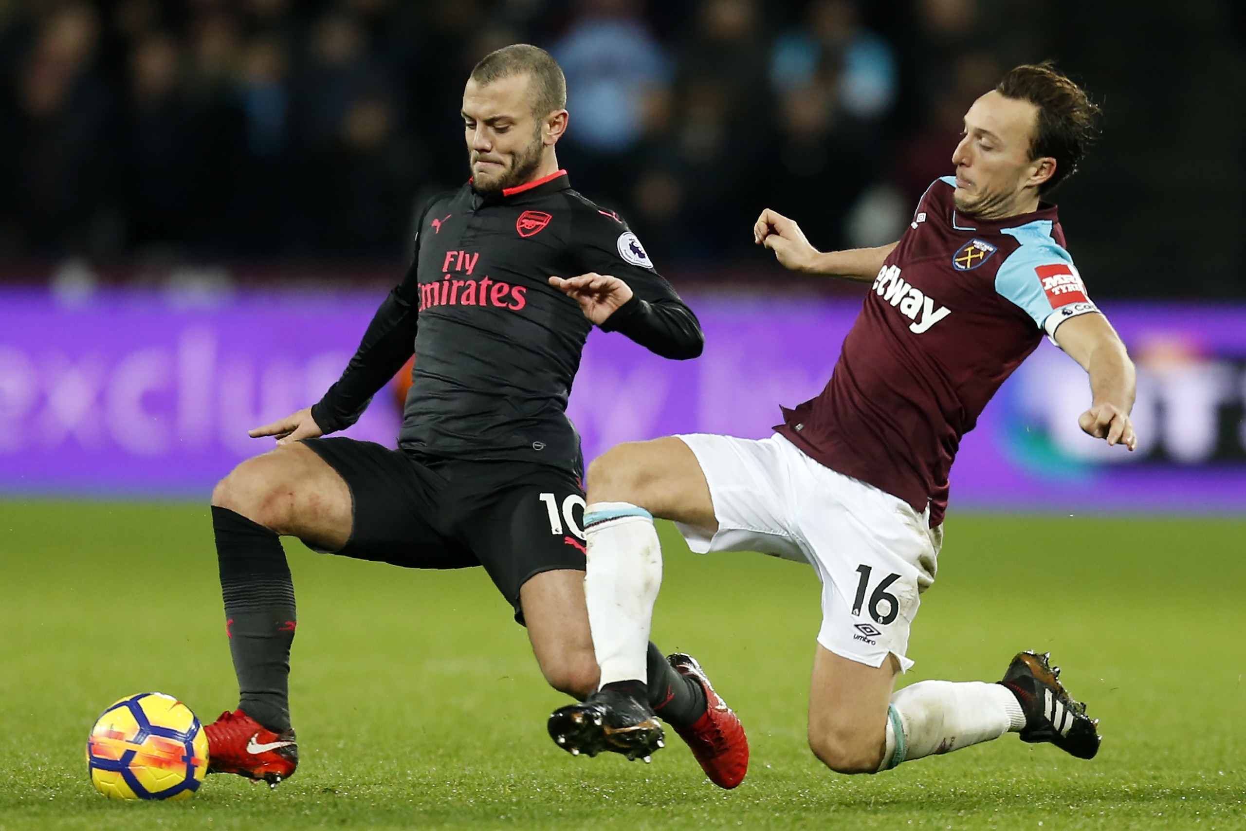 Arsenal's English midfielder Jack Wilshere (L) vies with West Ham United's English midfielder Mark Noble during the English Premier League football match between West Ham United and Arsenal at The London Stadium, in east London on December 13, 2017. / AFP