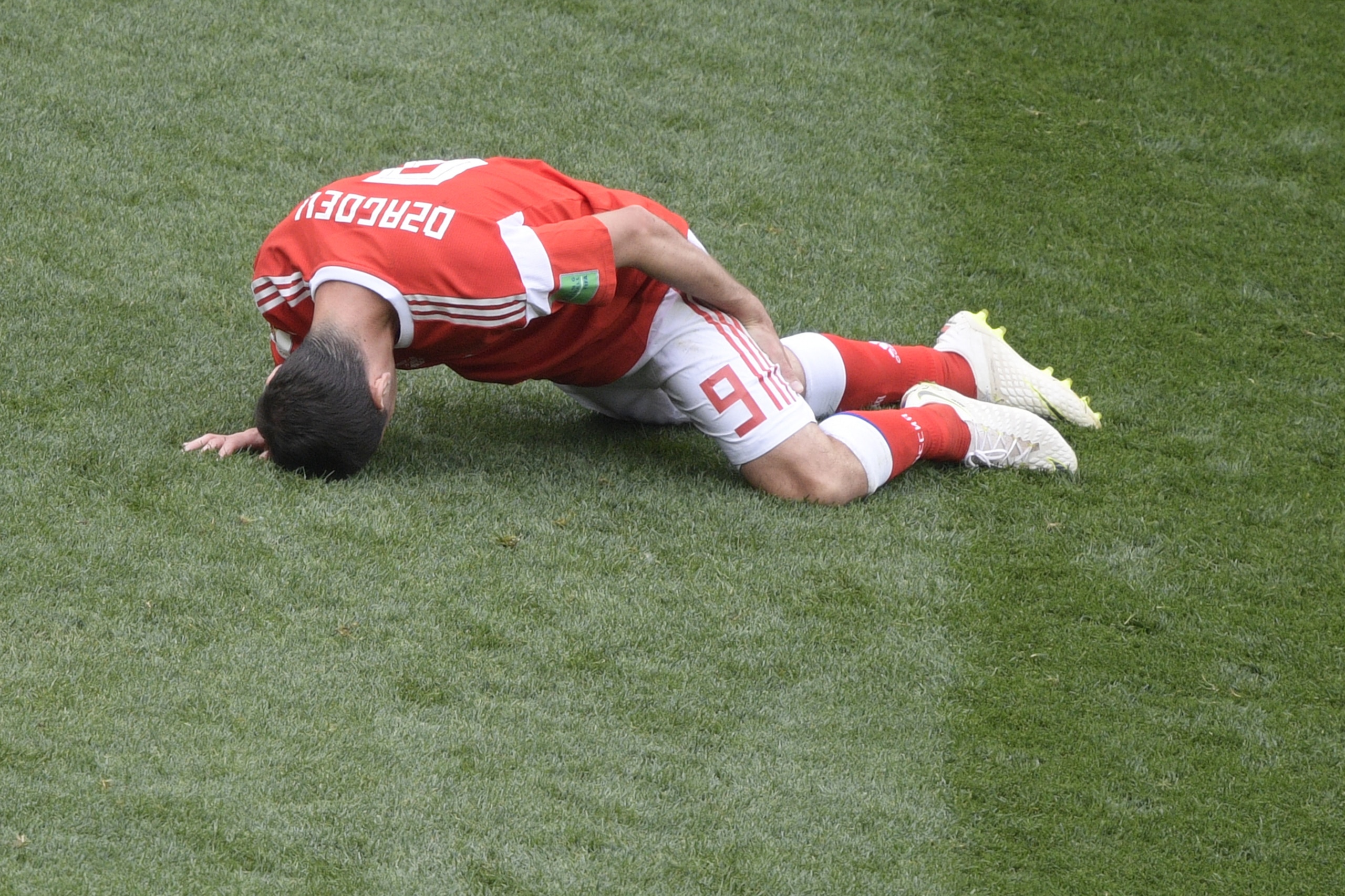 Russia's midfielder Alan Dzagoev reacts after injuring himself during the Russia 2018 World Cup Group A football match between Russia and Saudi Arabia at the Luzhniki Stadium in Moscow on June 14, 2018. (Photo by Juan Mabromata / AFP) / RESTRICTED TO EDIT