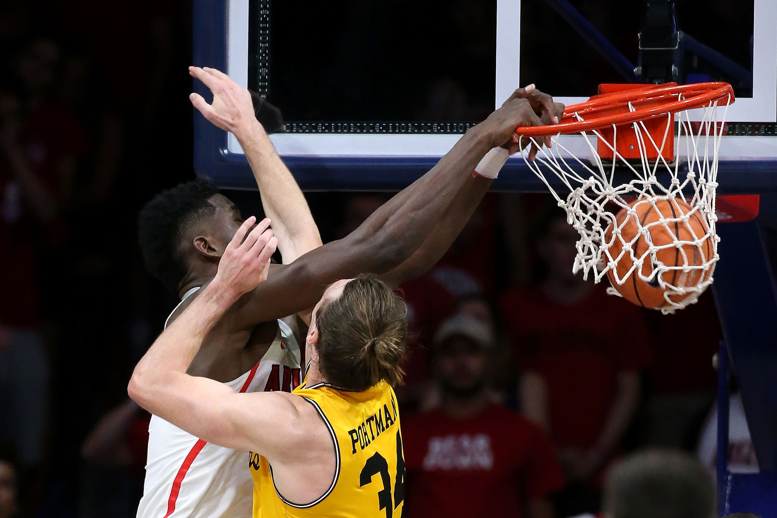 TUCSON, AZ - NOVEMBER 12: Deandre Ayton #13 of the Arizona Wildcats dunks over Max Portmann #34 of the UMBC Retrievers during the first half of the college basketball game at McKale Center on November 12, 2017 in Tucson, Arizona. The Wildcats beat the Ret