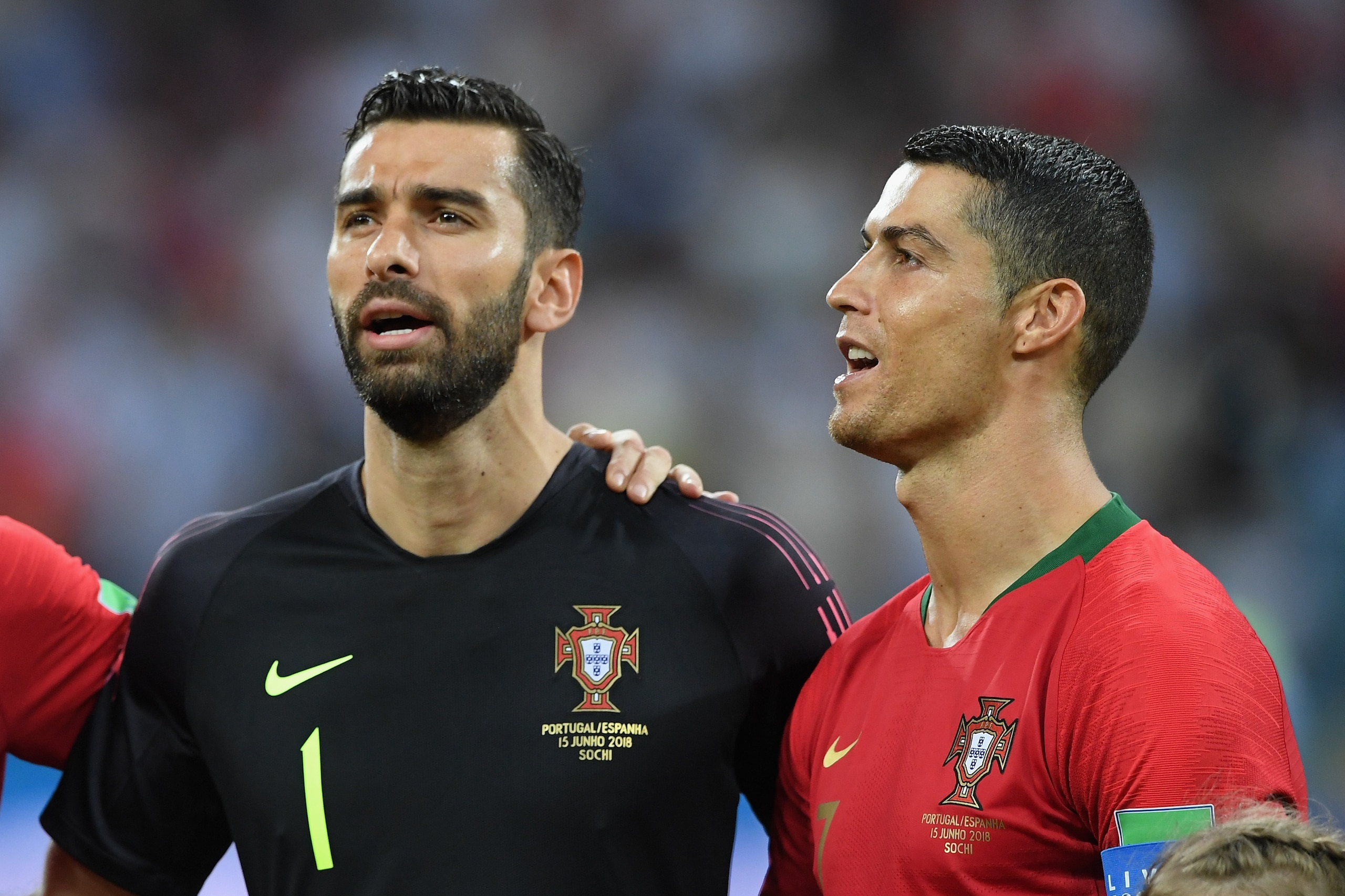 SOCHI, RUSSIA - JUNE 15:  Portugal player Cristiano Ronaldo (r) looks on during the singing of the national anthem with Pepe (l) and Rui Patricio during the 2018 FIFA World Cup Russia group B match between Portugal and Spain at Fisht Stadium on June 15, 2