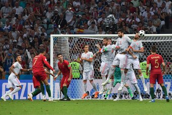 Portugal's forward Cristiano Ronaldo (2L) shoots to score his third goal during the Russia 2018 World Cup Group B football match between Portugal and Spain at the Fisht Stadium in Sochi on June 15, 2018. (Photo by Nelson Almeida / AFP) / RESTRICTED TO EDI