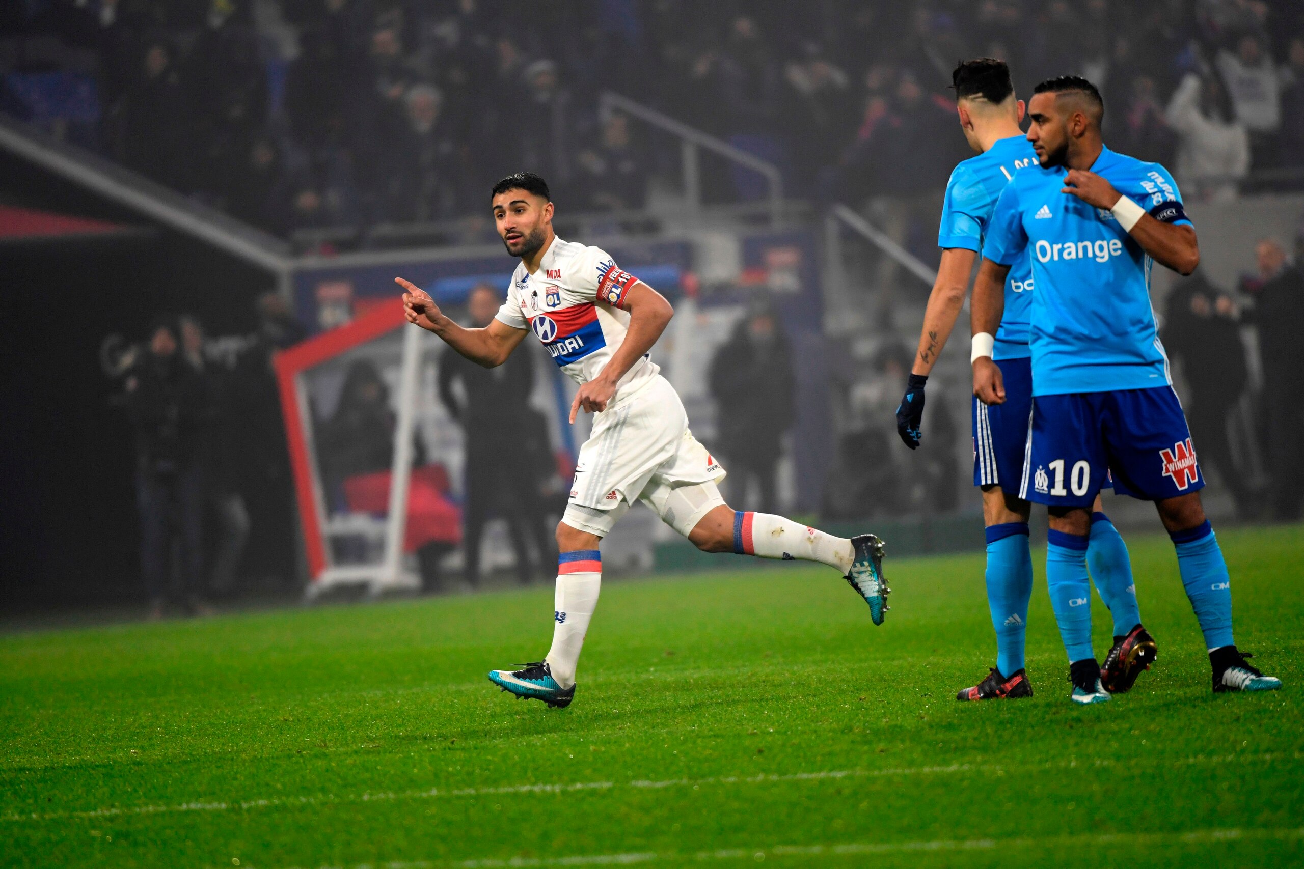 Lyon's French forward Nabil Fekir (L) celebrates after scoring a goal during the French L1 football match between Lyon (OL) and Marseille (OM) on December 17, 2017, at the Groupama stadium in Decines-Charpieu near Lyon, central-eastern France. / AFP PHOTO
