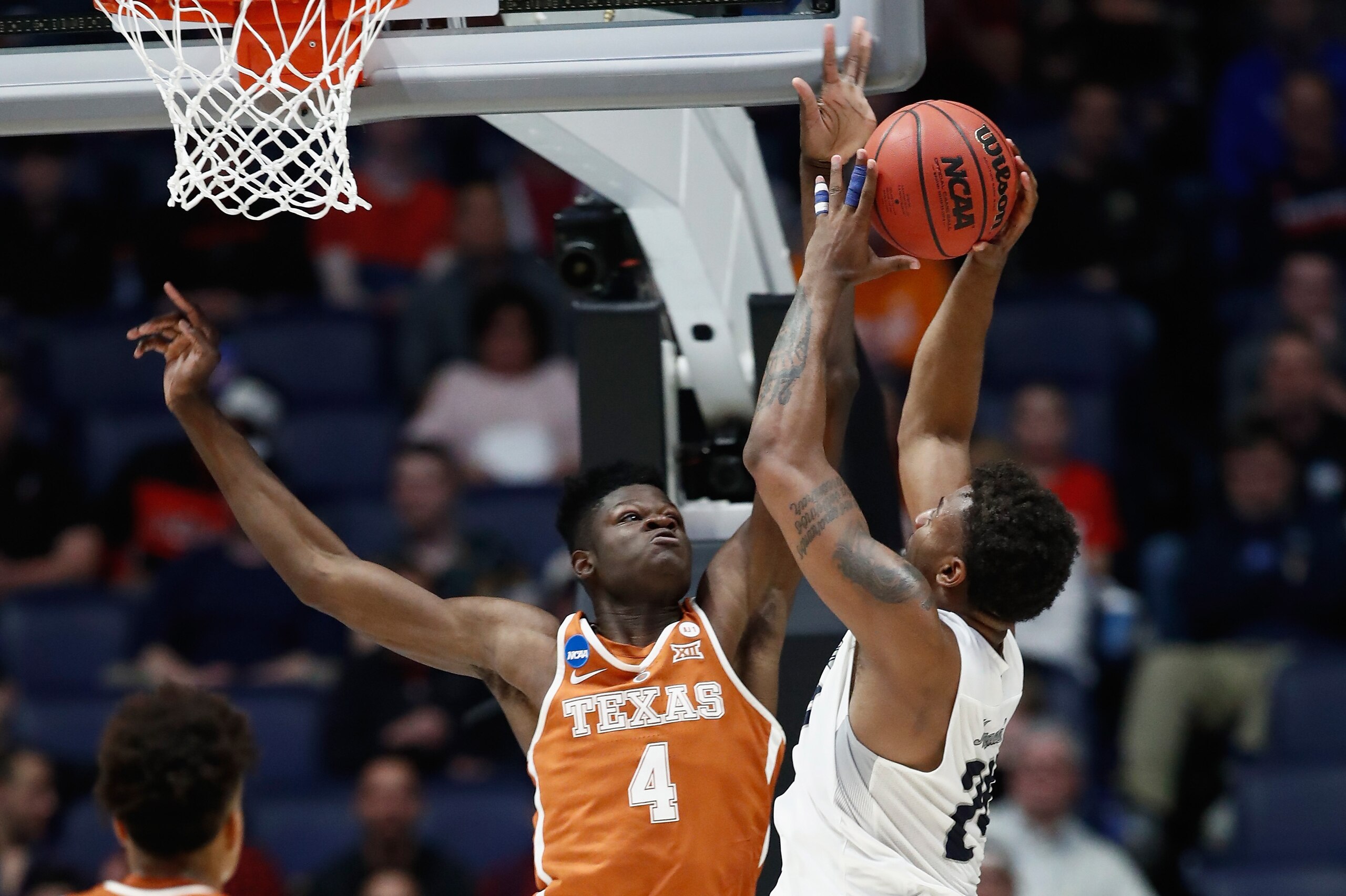 NASHVILLE, TN - MARCH 16:  Mohamed Bamba #4 of the Texas Longhorns blocks a shot by Jordan Caroline #24 of the Nevada Wolf Pack during the game in the first round of the 2018 NCAA Men's Basketball Tournament at Bridgestone Arena on March 16, 2018 in Nashv