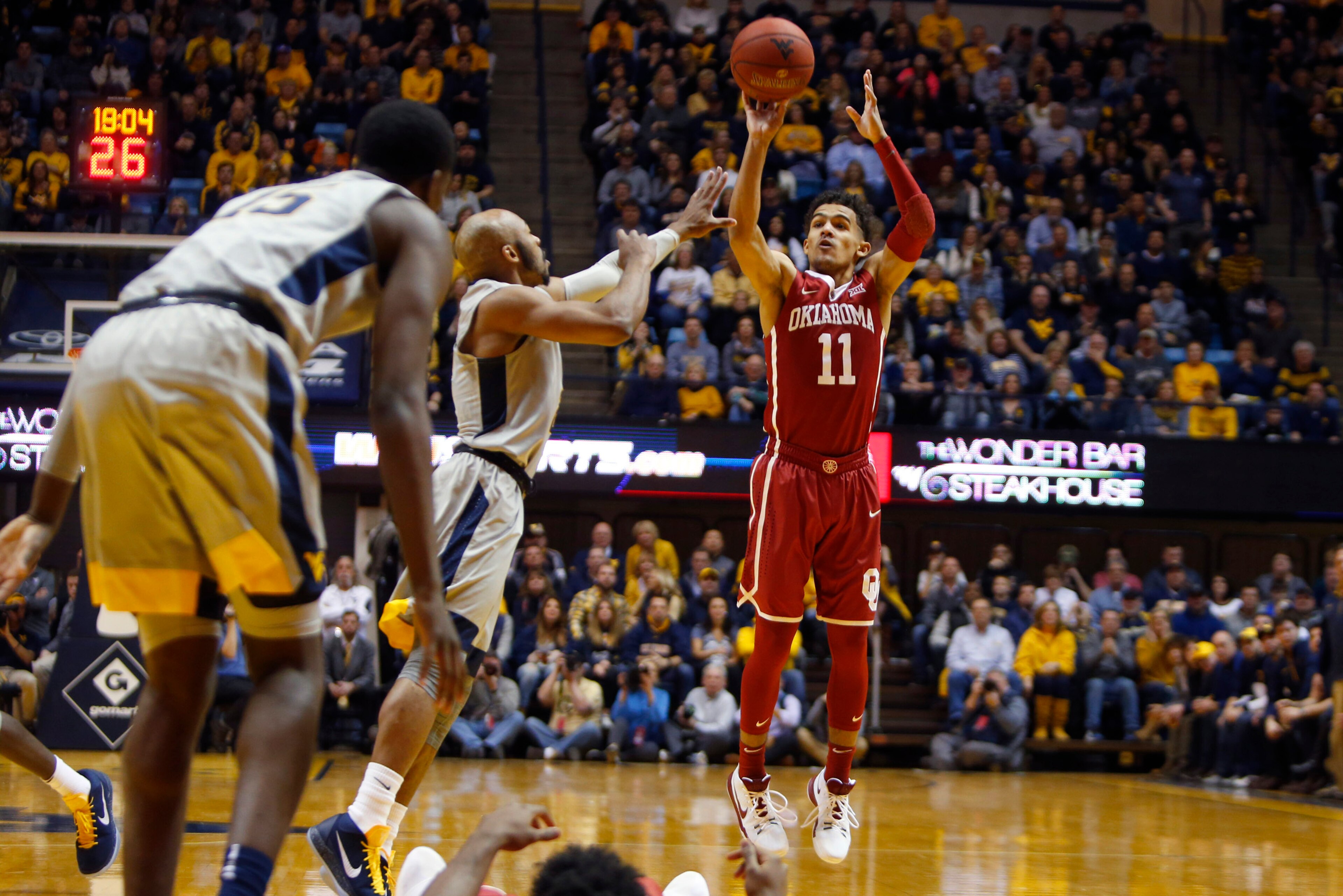 MORGANTOWN, WV - JANUARY 06:  Trae Young #11 of the Oklahoma Sooners pulls up for three against the West Virginia Mountaineers at the WVU Coliseum on January 6, 2018 in Morgantown, West Virginia.  (Photo by Justin K. Aller/Getty Images)