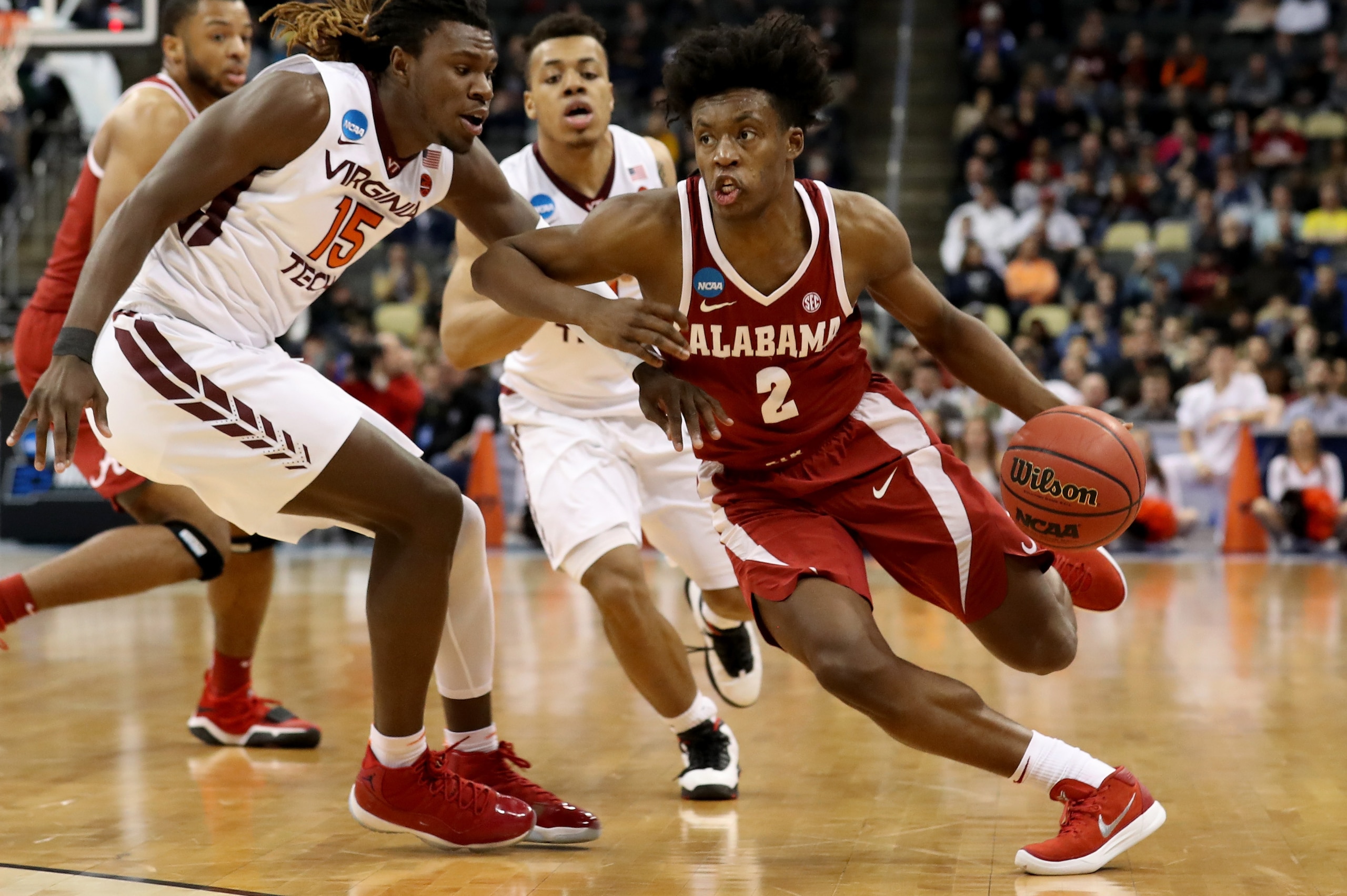 PITTSBURGH, PA - MARCH 15:  Collin Sexton #2 of the Alabama Crimson Tide drives to the basket against Chris Clarke #15 of the Virginia Tech Hokies during the second half of the game in the first round of the 2018 NCAA Men's Basketball Tournament at PPG PA