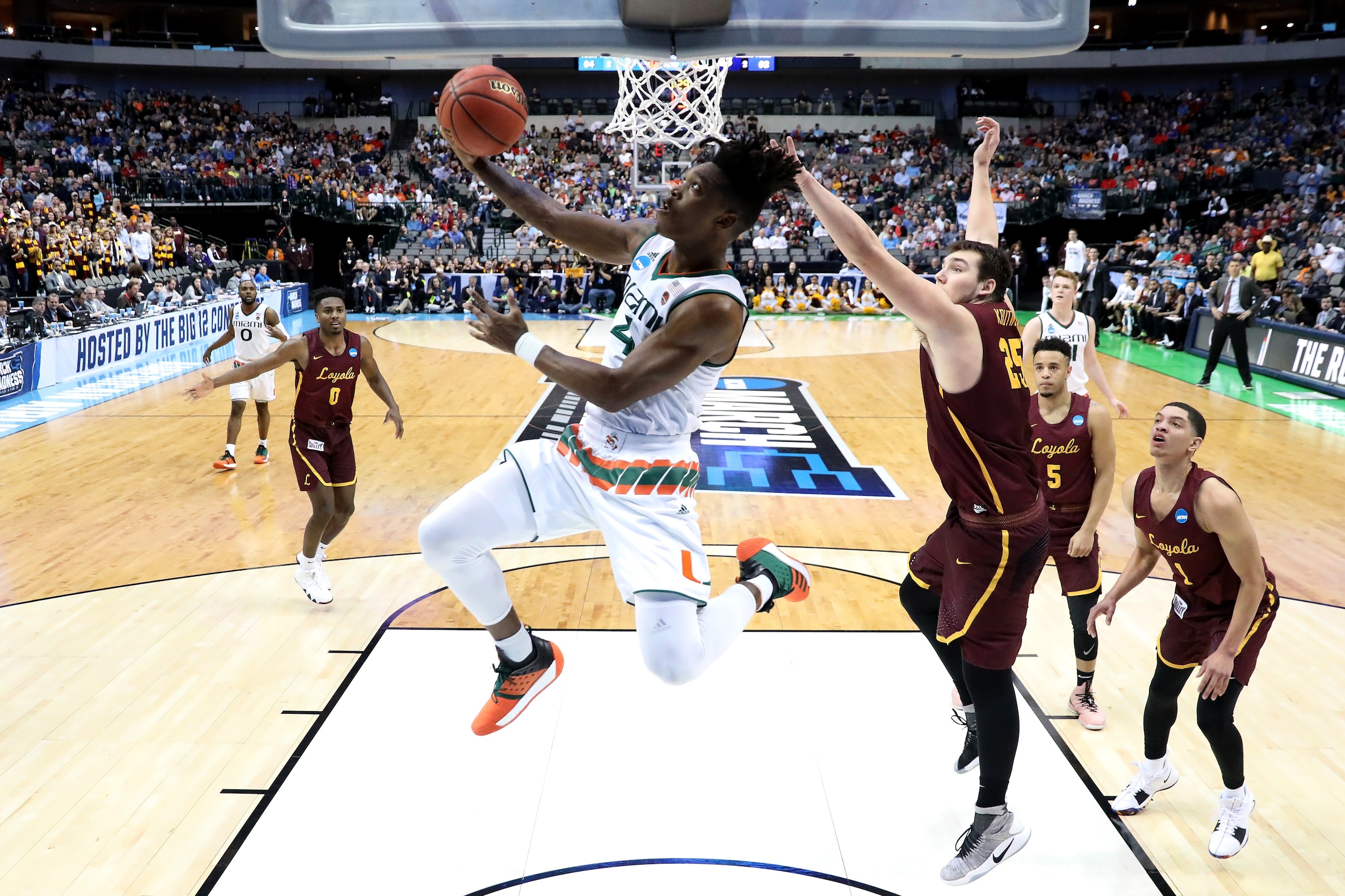 DALLAS, TX - MARCH 15:  Lonnie Walker IV #4 of the Miami Hurricanes goes up for a shot against Cameron Krutwig #25 of the Loyola Ramblers in the first round of the 2018 NCAA Men's Basketball Tournament at American Airlines Center on March 15, 2018 in Dall