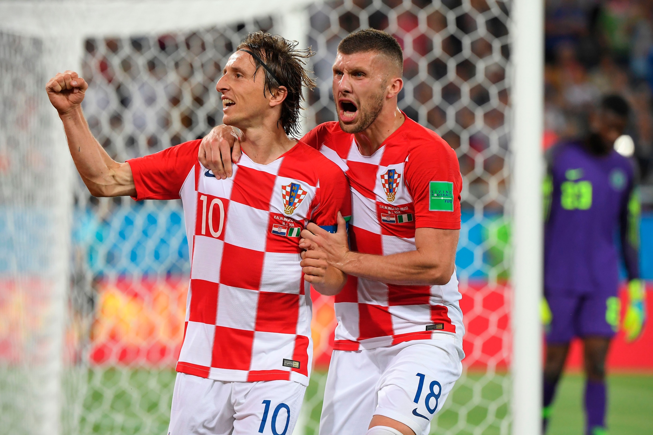 Croatia's midfielder Luka Modric (L) celebrates scoring a penalty with his teammate forward Ante Rebic during the Russia 2018 World Cup Group D football match between Croatia and Nigeria at the Kaliningrad Stadium in Kaliningrad on June 16, 2018. (Photo b