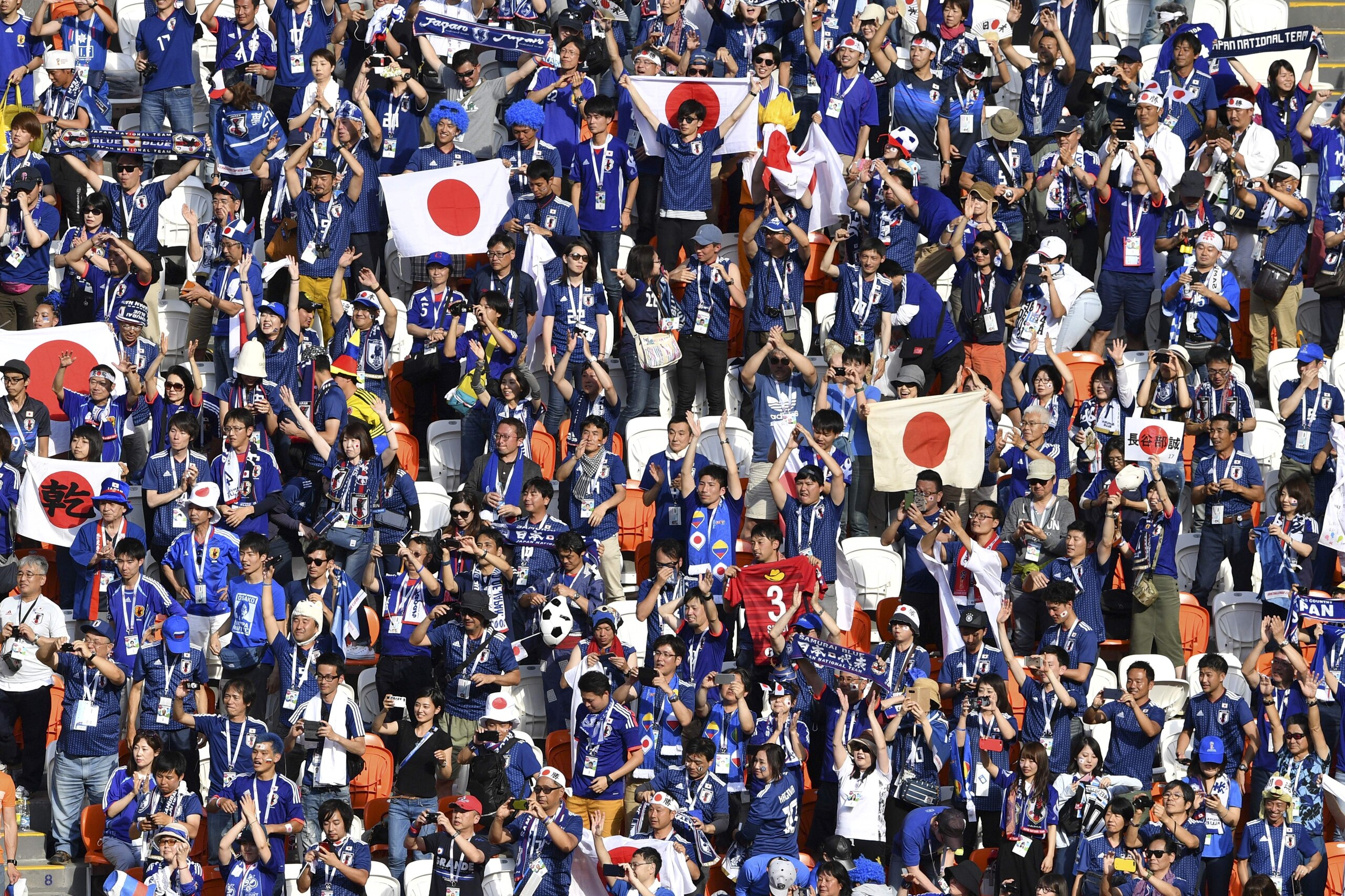 Japan's fans celebrate their 2-1 victory at the end of the Russia 2018 World Cup Group H football match between Colombia and Japan at the Mordovia Arena in Saransk on June 19, 2018. (Photo by Mladen ANTONOV / AFP) / RESTRICTED TO EDITORIAL USE - NO MOBILE