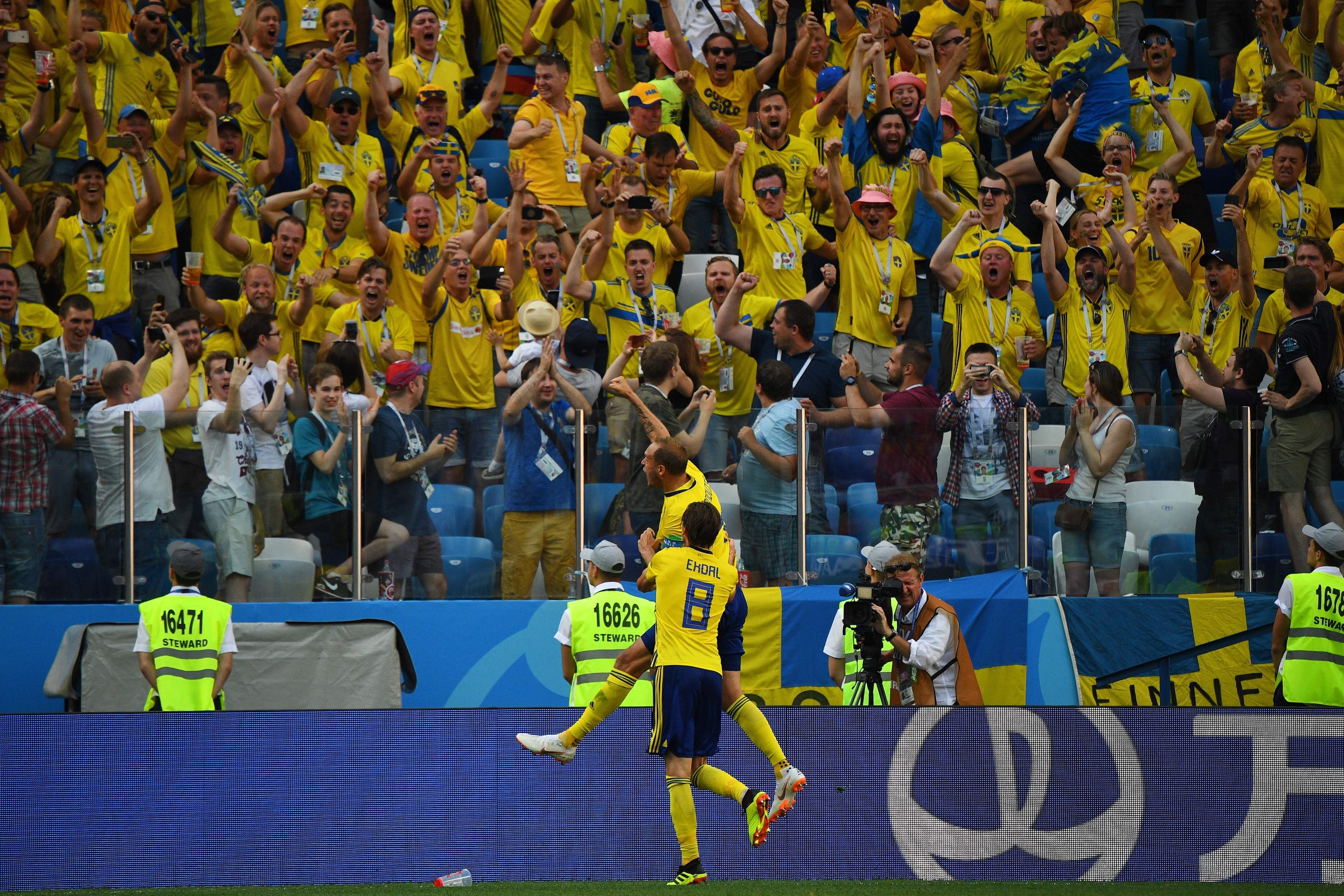 Sweden's defender Andreas Granqvist (top) celebrates after scoring a penalty during the Russia 2018 World Cup Group F football match between Sweden and South Korea at the Nizhny Novgorod Stadium in Nizhny Novgorod on June 18, 2018. (Photo by Johannes EISE