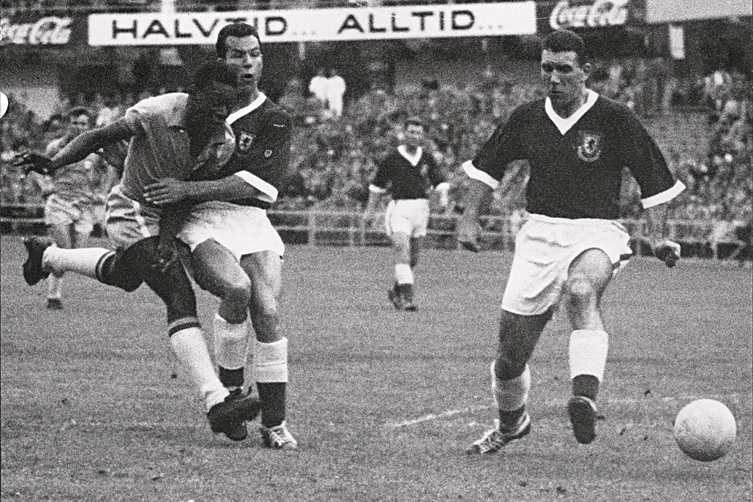 17-year-old Brazilian forward Pele (L) kicks the ball past two Welsh defenders during the World Cup quarterfinal soccer match between Brazil and Wales 19 June 1958 in Goteborg. Pele scored the only goal of the match to help Brazil advance to the semifinal