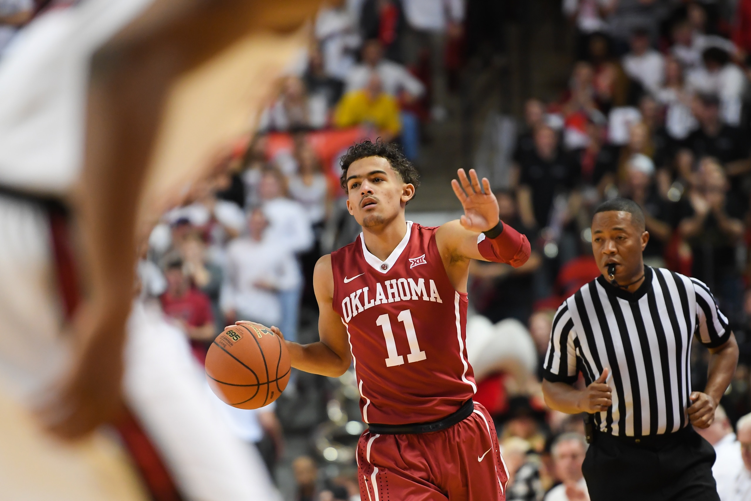 LUBBOCK, TX - FEBRUARY 13: Trae Young #11 of the Oklahoma Sooners handles the ball during the game against the Texas Tech Red Raiders on February 13, 2018 at United Supermarket Arena in Lubbock, Texas. Texas Tech defeated Oklahoma 88-78. (Photo by John We