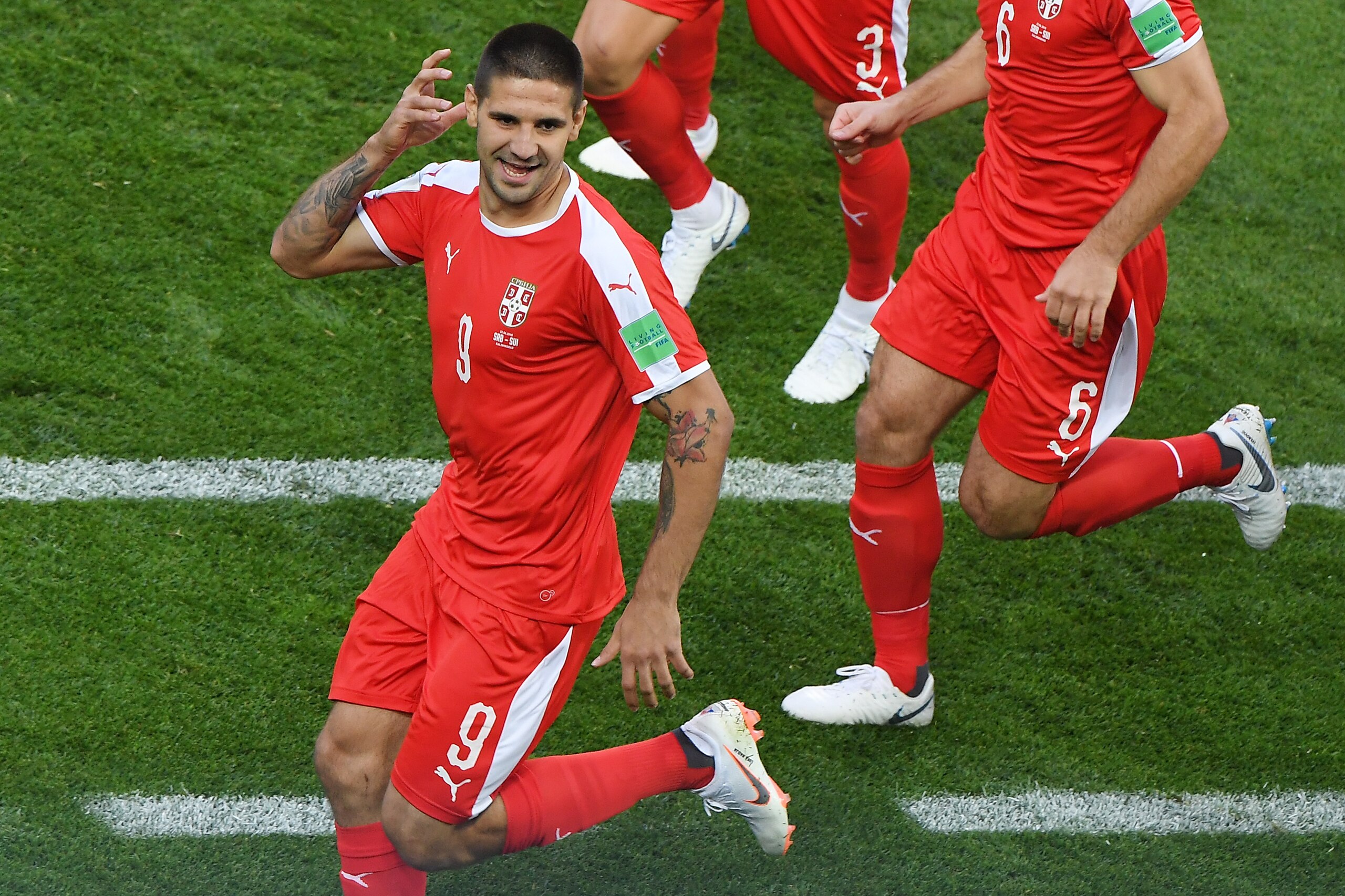 Serbia's forward Aleksandar Mitrovic (L) celebrates   after scoring the opening goal during the Russia 2018 World Cup Group E football match between Serbia and Switzerland at the Kaliningrad Stadium in Kaliningrad on June 22, 2018. (Photo by Patrick HERTZ