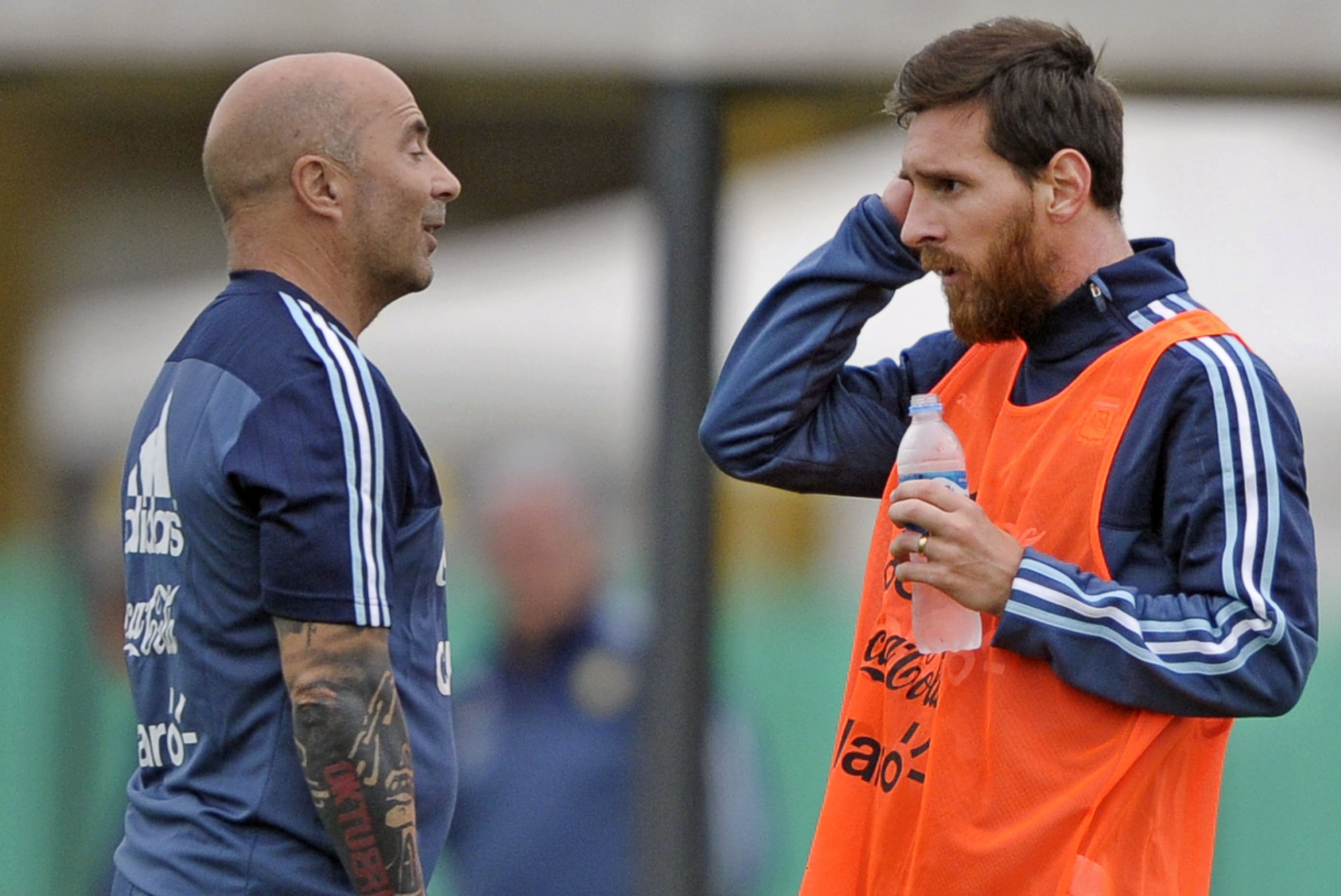 Argentina's forward Lionel Messi (R) talks with his coach Jorge Sampaoli during a training session in Ezeiza, Buenos Aires on August 28, 2017, ahead of a 2018 FIFA World Cup Russia South American qualifier football match against Uruguay to be held in Mont