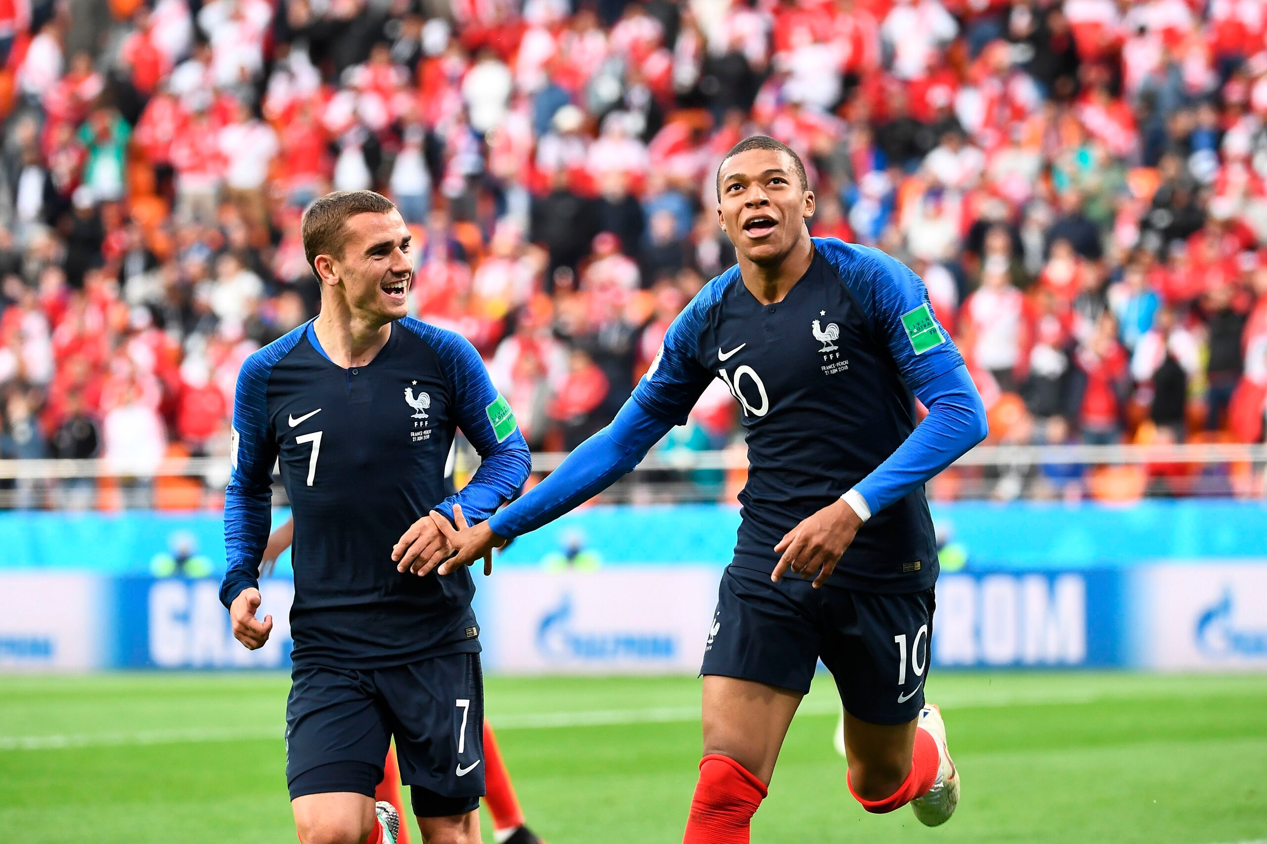 TOPSHOT - France's forward Kylian Mbappe (R) celebrates scoring the opening goal with his teammate forward Antoine Griezmann during the Russia 2018 World Cup Group C football match between France and Peru at the Ekaterinburg Arena in Ekaterinburg on June 
