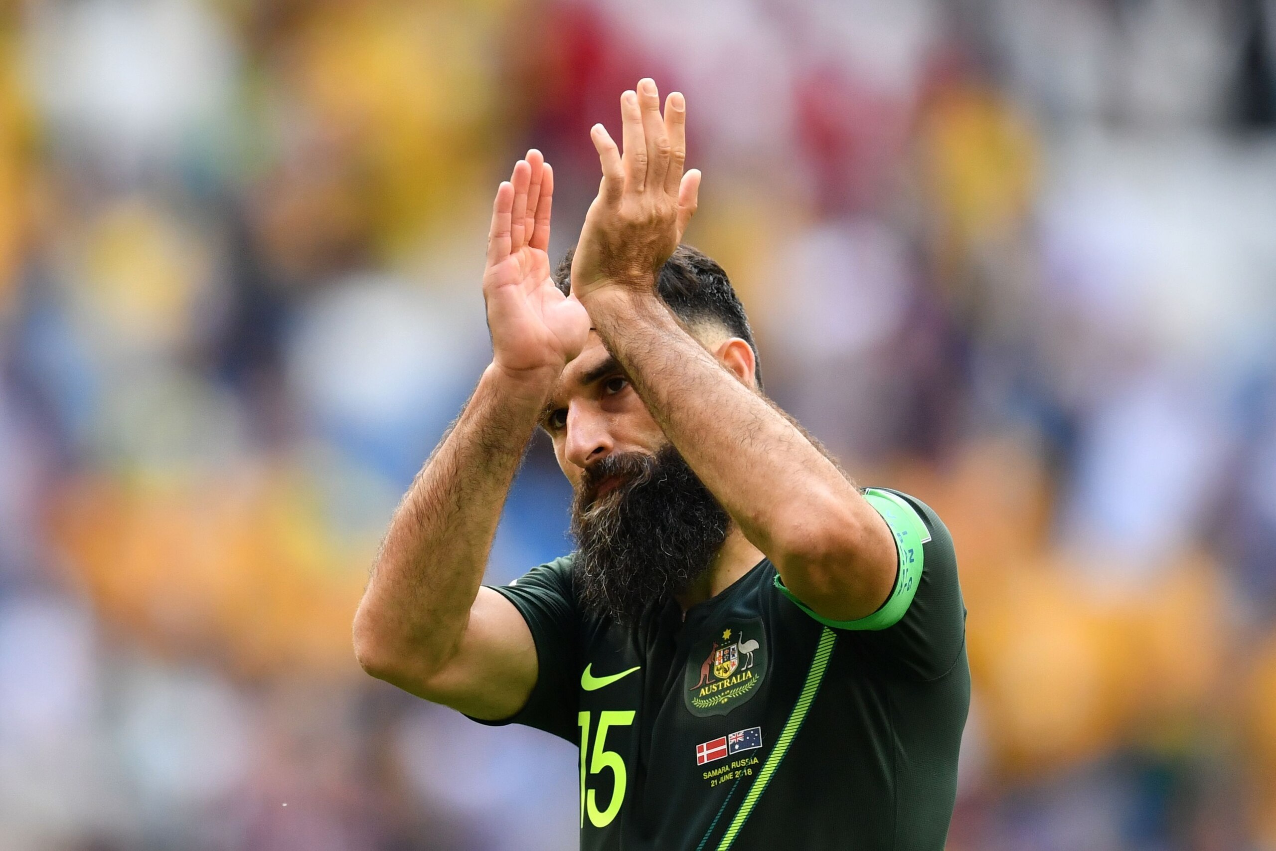 TOPSHOT - Australia's midfielder Mile Jedinak applauds the crowd after the final whistle during the Russia 2018 World Cup Group C football match between Denmark and Australia at the Samara Arena in Samara on June 21, 2018. (Photo by Fabrice COFFRINI / AFP