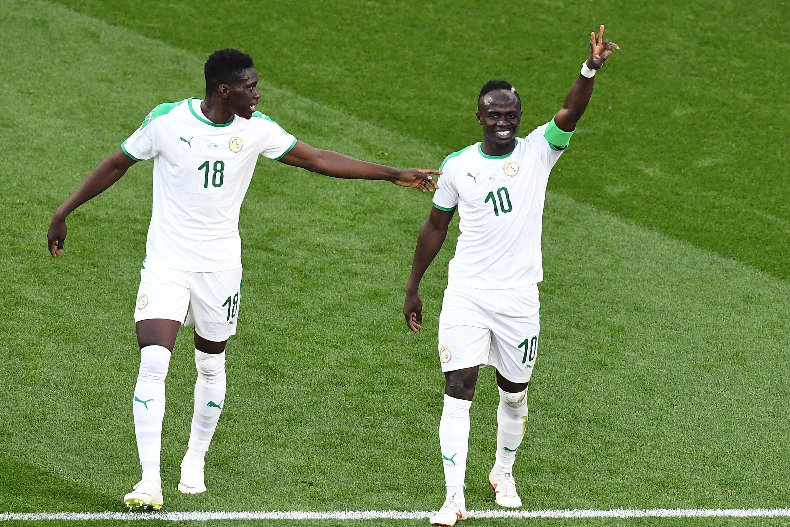Senegal's forward Sadio Mane (R) celebrates a goal with Senegal's forward Ismaila Sarr during the Russia 2018 World Cup Group H football match between Japan and Senegal at the Ekaterinburg Arena in Ekaterinburg on June 24, 2018. (Photo by Anne-Christine P