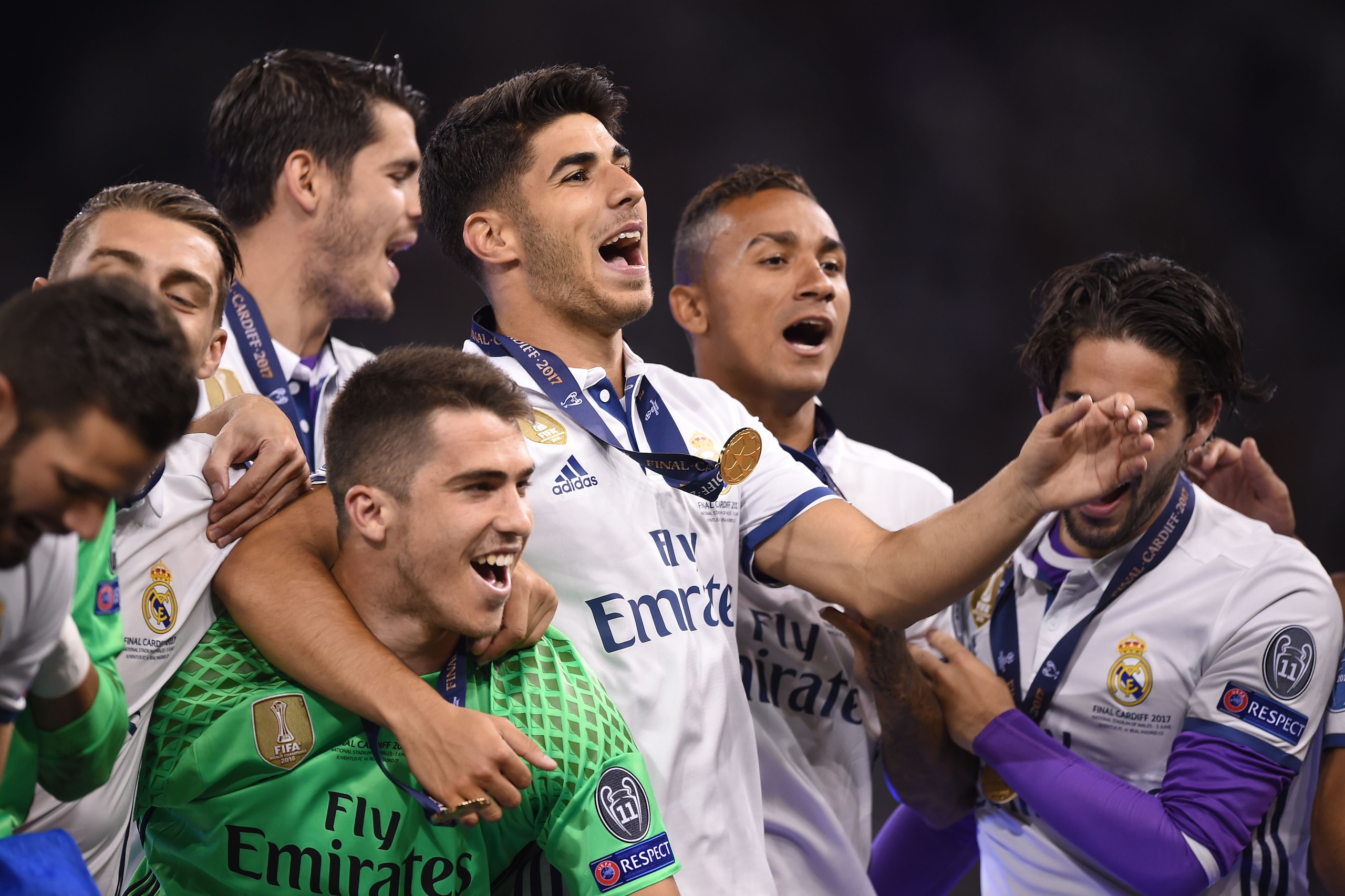 (FromL0 Real Madrid's Spanish goalkeeper Ruben Yanez, Real Madrid's Spanish midfielder Marco Asensio and Real Madrid's Brazilian defender Danilo celebrate with teammates after Real Madrid won the UEFA Champions League final football match between Juventus