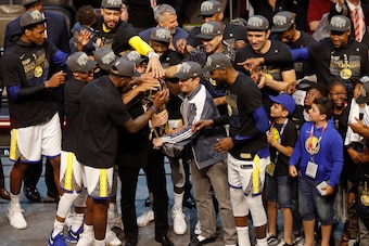 CLEVELAND, OH - JUNE 8: The Golden State Warriors celebrate on stage with the Larry O'Brien Championship Trophy after winning Game Four of the 2018 NBA Finals against the Cleveland Cavaliers on June 8, 2018 at Quicken Loans Arena in Cleveland, Ohio. NOTE CLEVELAND, OH - JUNE 8: The Golden State Warriors celebrate on stage with the Larry O'Brien Championship Trophy after winning Game Four of the 2018 NBA Finals against the Cleveland Cavaliers on June 8, 2018 at Quicken Loans Arena in Cleveland, Ohio. NOTE
