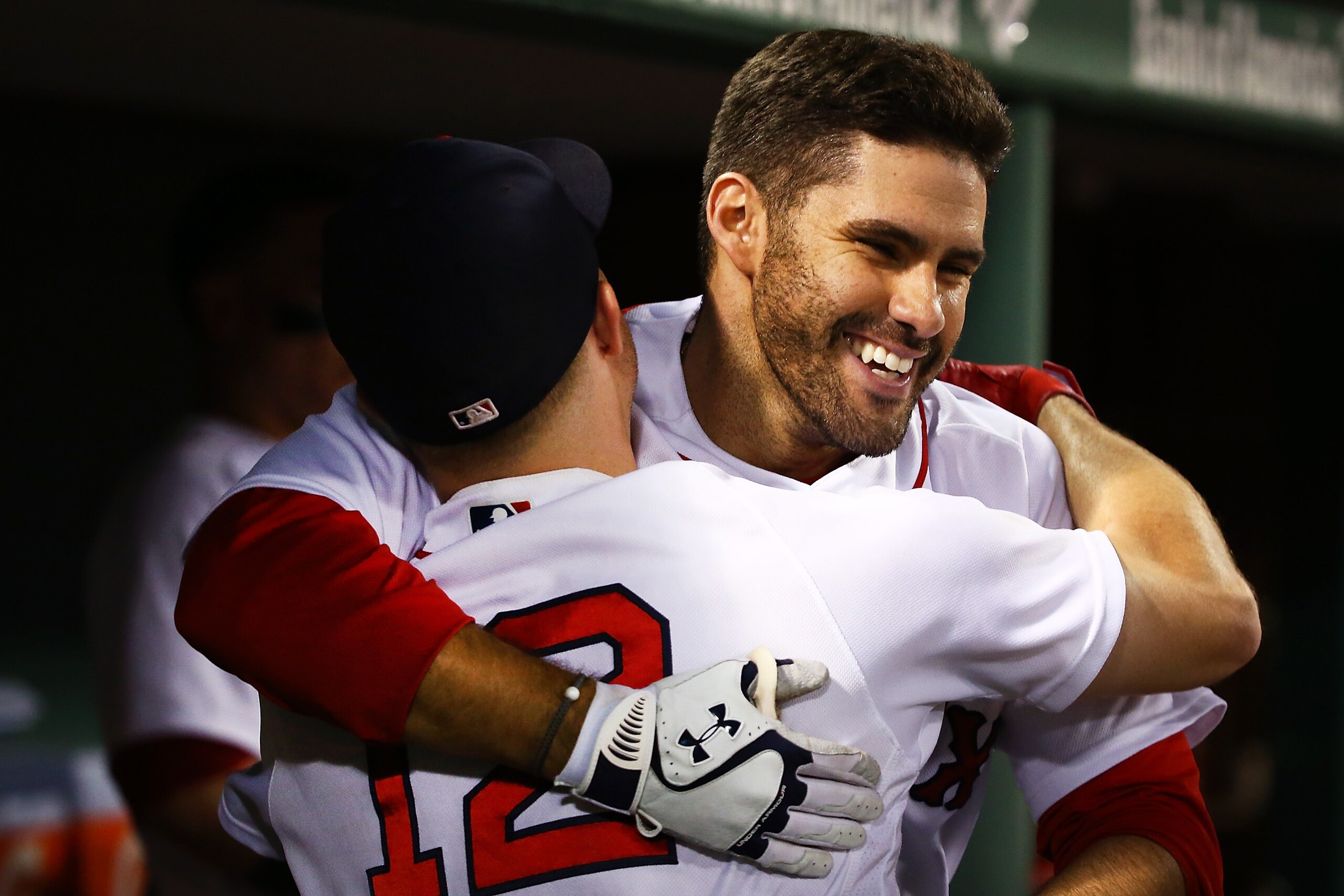BOSTON, MA - JUNE 26: J.D. Martinez #28 hugs Brock Holt #12 of the Boston Red Sox in the dugout after hitting a solo home run in the sixth inning of a game against the Los Angeles Angels at Fenway Park on June 26, 2018 in Boston, Massachusetts. (Photo b BOSTON, MA - JUNE 26: J.D. Martinez #28 hugs Brock Holt #12 of the Boston Red Sox in the dugout after hitting a solo home run in the sixth inning of a game against the Los Angeles Angels at Fenway Park on June 26, 2018 in Boston, Massachusetts. (Photo b