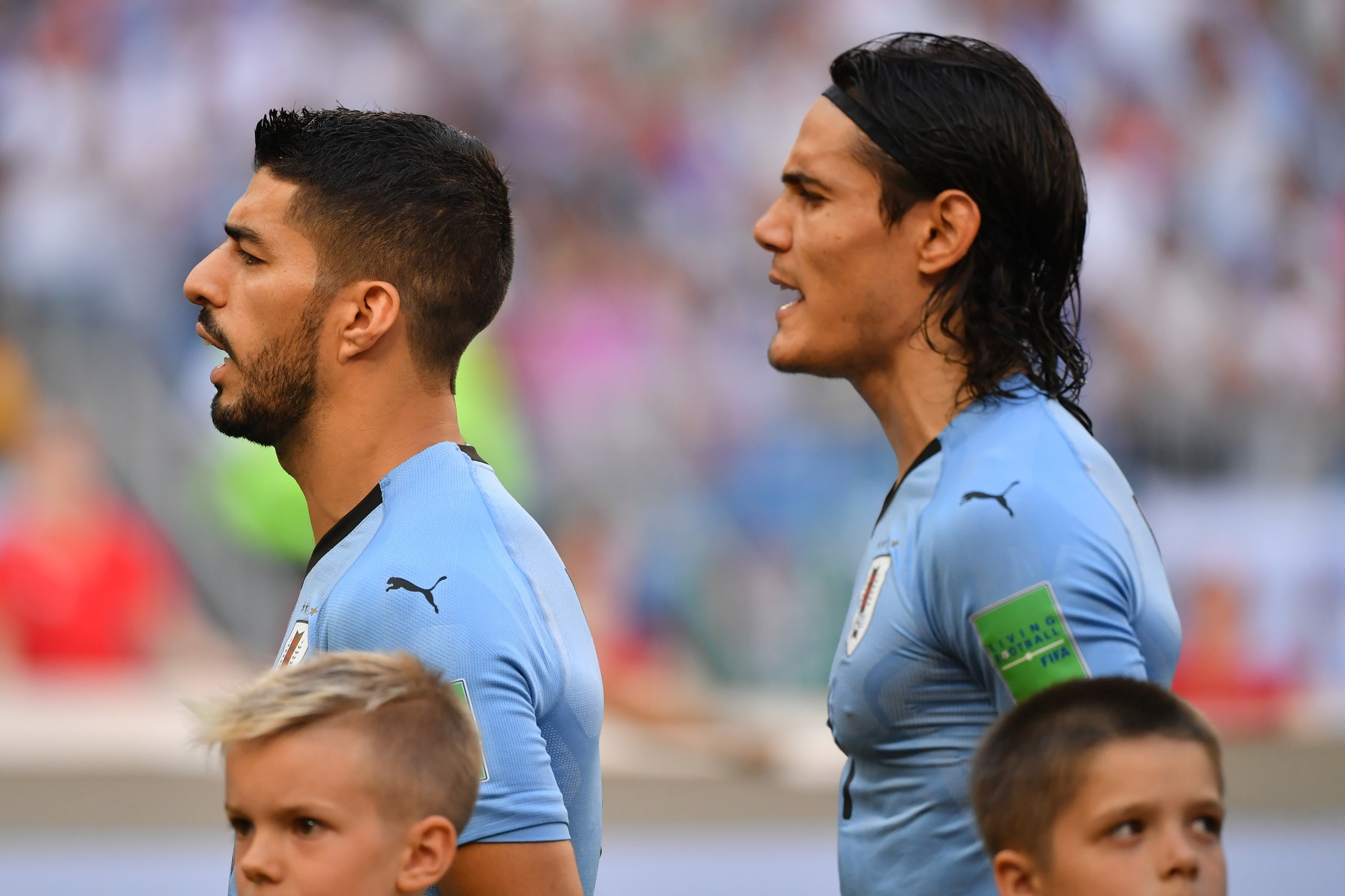 Uruguay's forward Luis Suarez (L) and Uruguay's forward Edinson Cavani sing Uruguay's national anthem before the start of the Russia 2018 World Cup Group A football match between Uruguay and Russia at the Samara Arena in Samara on June 25, 2018. (Photo by