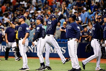 ST PETERSBURG, FL - JUNE 30: Sergio Romo #54 of the Tampa Bay Rays celebrates with first base coach Ozzie Timmons #30 after a 5-2 win against the Houston Astros on June 30, 2018 at  Tropicana Field in St Petersburg, Florida. (Photo by Julio Aguilar/Getty 