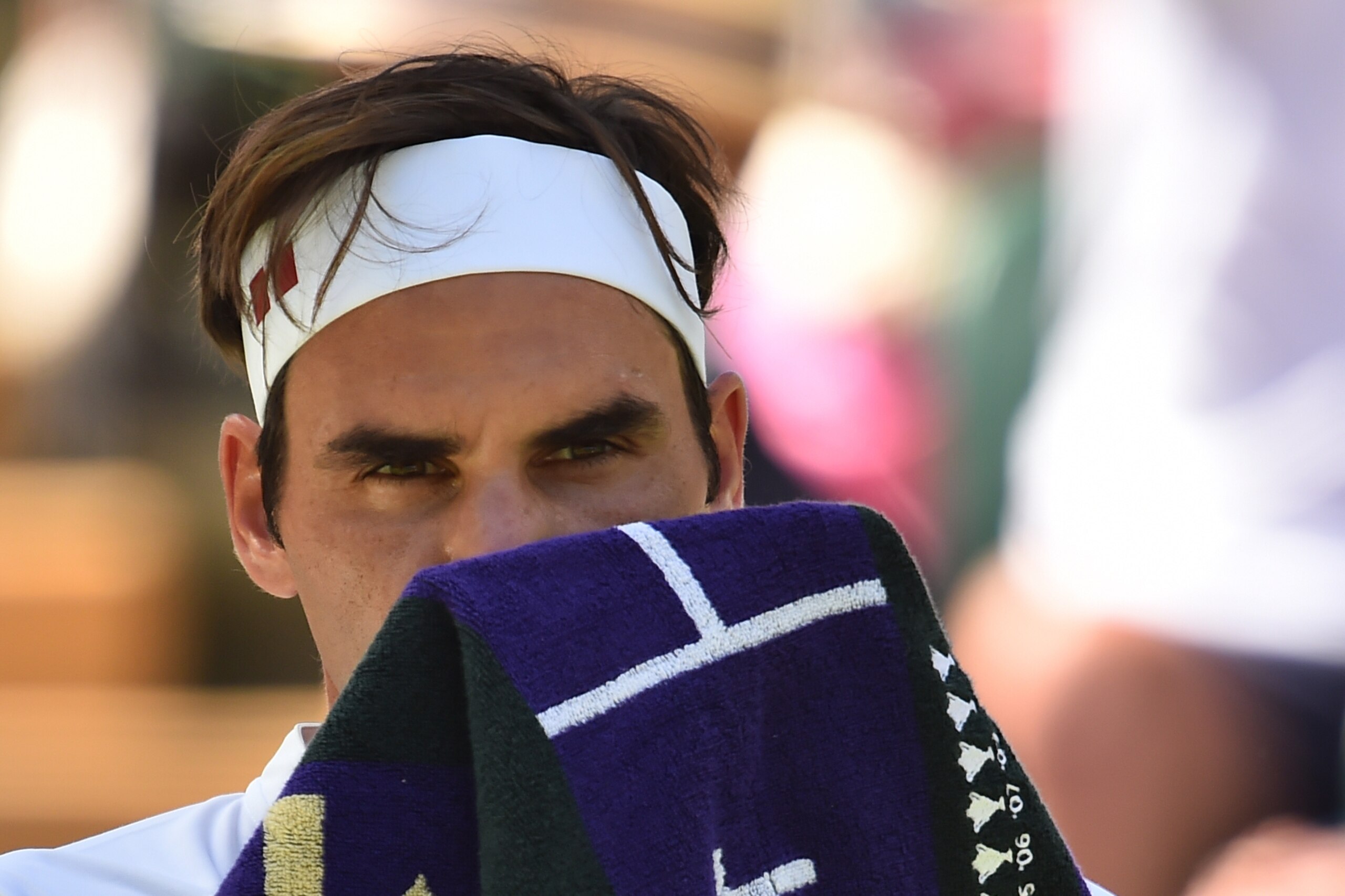 Switzerland's Roger Federer takes a break while playing Serbia's Dusan Lajovic during their men's singles first round match on the first day of the 2018 Wimbledon Championships at The All England Lawn Tennis Club in Wimbledon, southwest London, on July 2, Switzerland's Roger Federer takes a break while playing Serbia's Dusan Lajovic during their men's singles first round match on the first day of the 2018 Wimbledon Championships at The All England Lawn Tennis Club in Wimbledon, southwest London, on July 2,