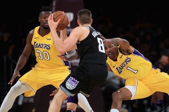 LOS ANGELES, CA - JANUARY 09:  Julius Randle #30 and Kentavious Caldwell-Pope #1 of the Los Angeles Lakers defend against Bogdan Bogdanovic #8 of the Sacramento Kings during the second half of a game at Staples Center on January 9, 2018 in Los Angeles, Ca