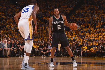 OAKLAND, CA - MAY 14:  Kawhi Leonard #2 of the San Antonio Spurs dribbles the ball while guarded by Kevin Durant #35 of the Golden State Warriors in Game One of the Western Conference Finals during the 2017 NBA Playoffs on May 14, 2017 at ORACLE Arena in 